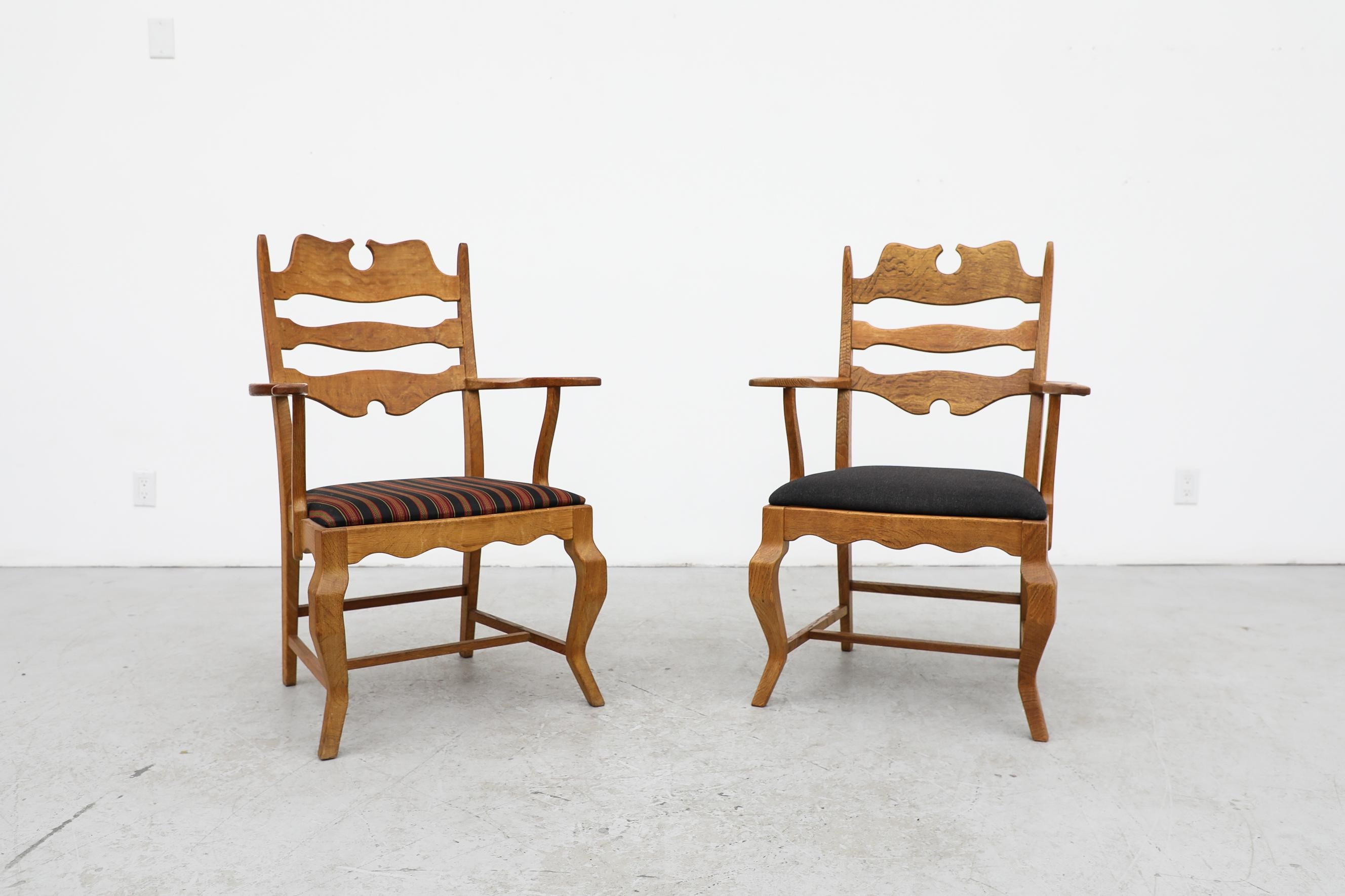 Brutalist razorback throne-like oak armchairs designed by prolific Danish designer Henning Kjaernulf. One chair has a grey upholstered seat, the other has black gold and red stripes. These chairs have been lightly refinished, mostly in original