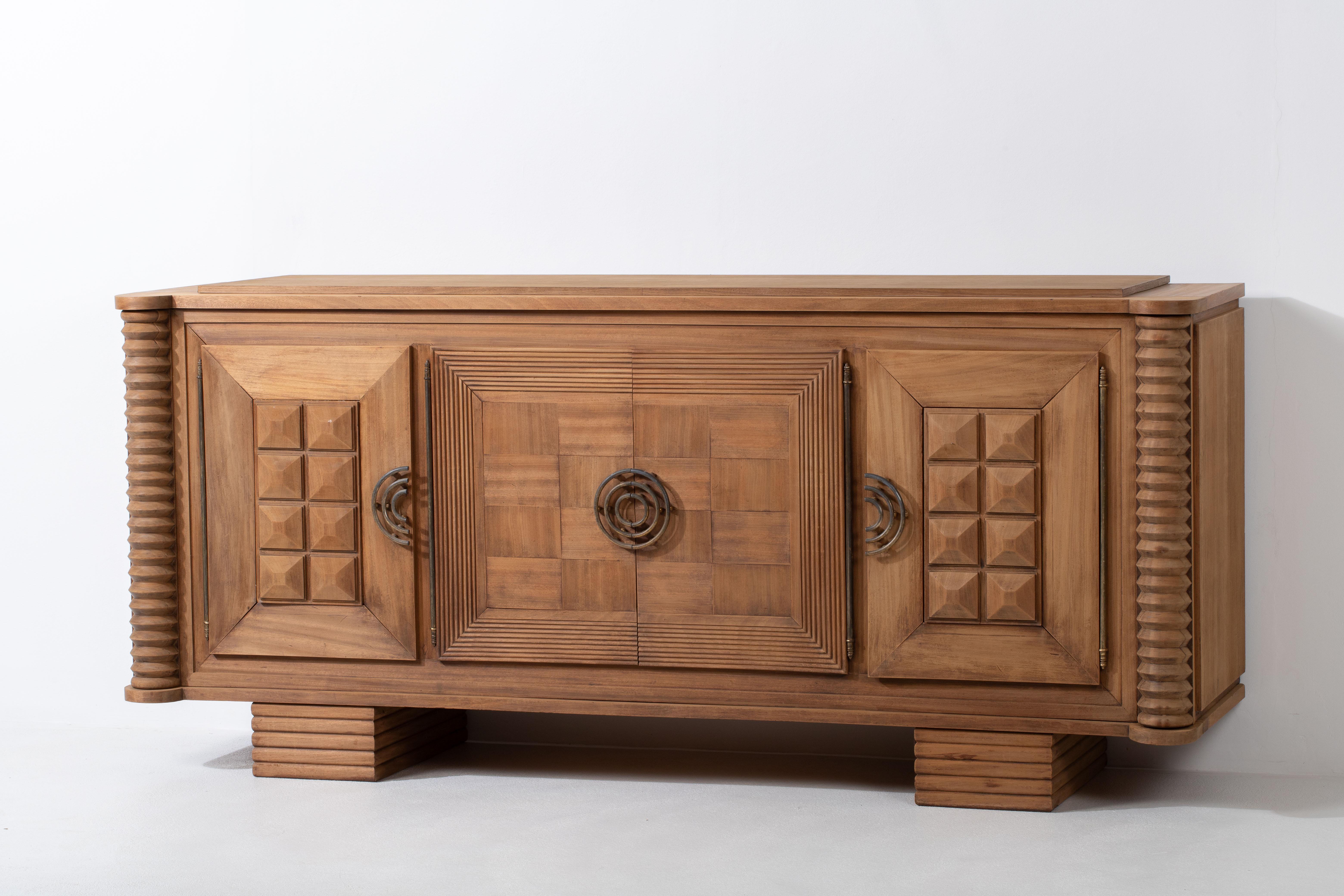 Introducing a captivating sculptural buffet, which draws inspiration from the renowned designer Charles Dudouyt. Dudouyt, a celebrated figure in the world of French furniture design, was known for his exceptional craftsmanship and innovative vision.