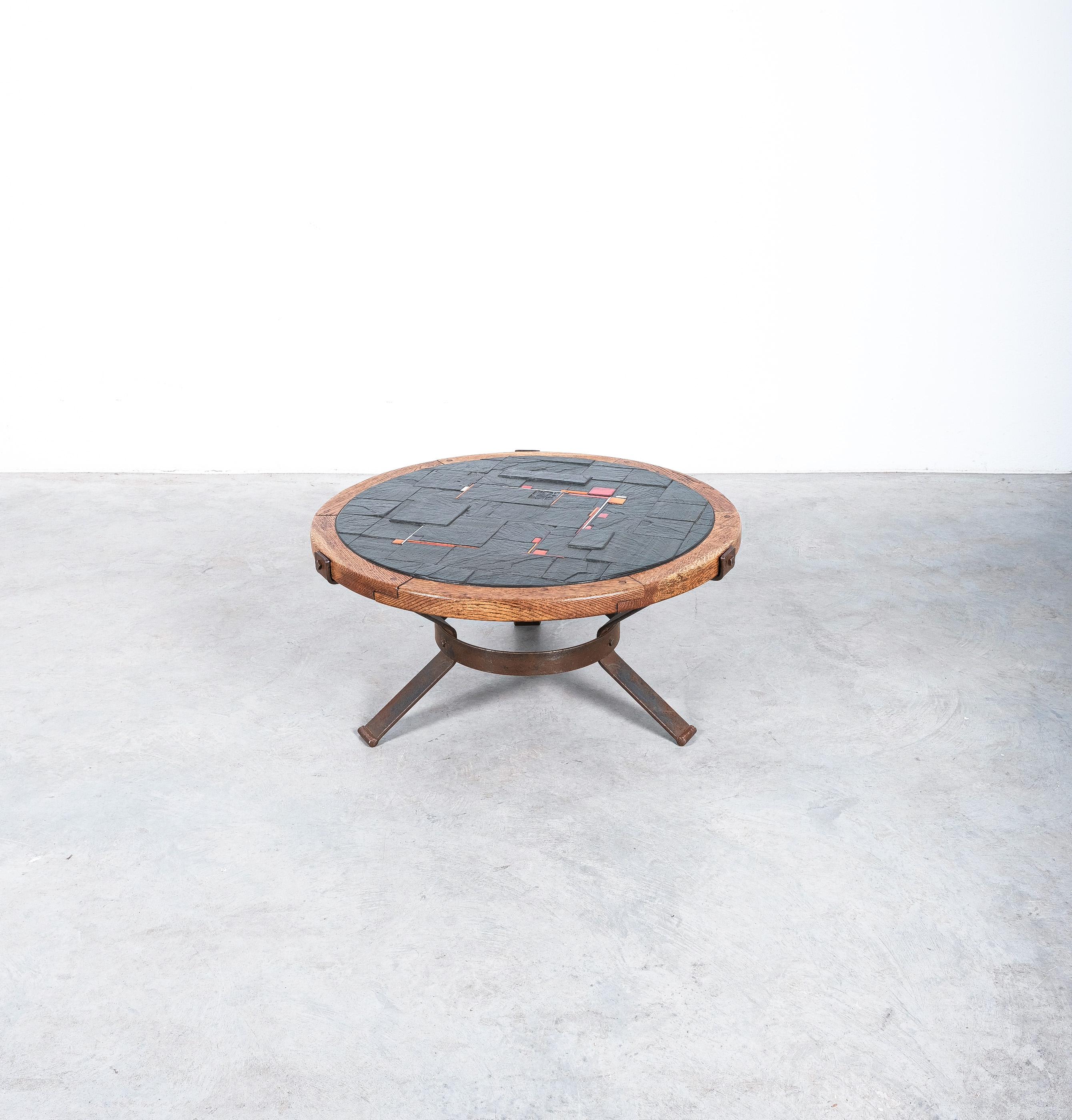 Midcentury oak and slate table on iron base, Belgium circa 1950

Dimensions are: 33.85