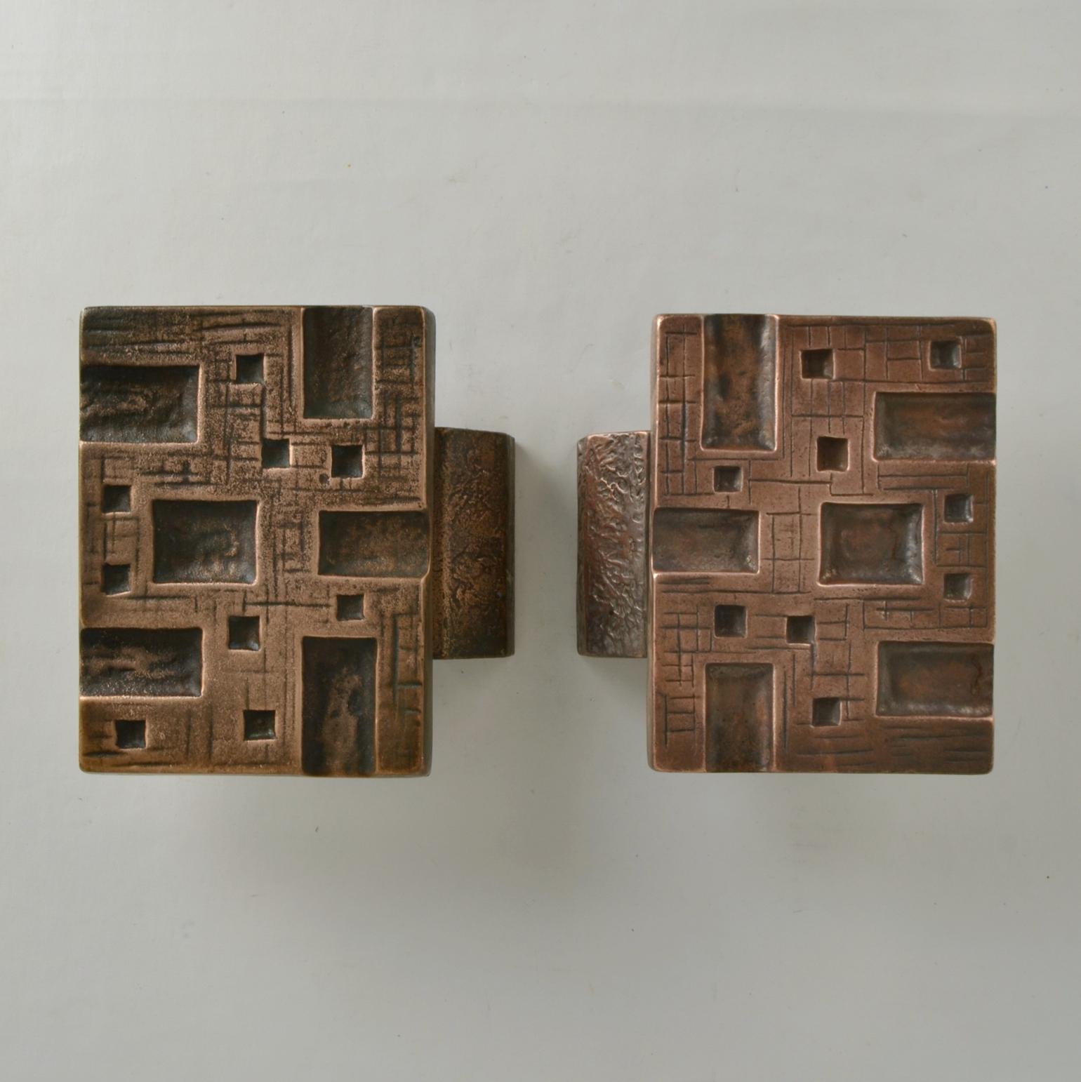 Brutalist pair of bronze relief with strong relief and geometric pattern with repetition of squares is made in the 1960-70's. These heavy pieces, made of cast bronze are in perfect condition. The bronze is oyidized, creating a patina to the textured