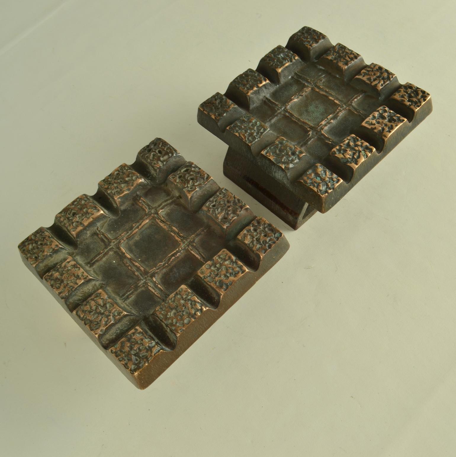 Brutalist pair of bronze relief with strong relief and geometric pattern with repetition of squares is made in the 1960-70's. These heavy pieces, made of cast bronze are in perfect condition. The bronze is oyidized, creating a strong patina to the