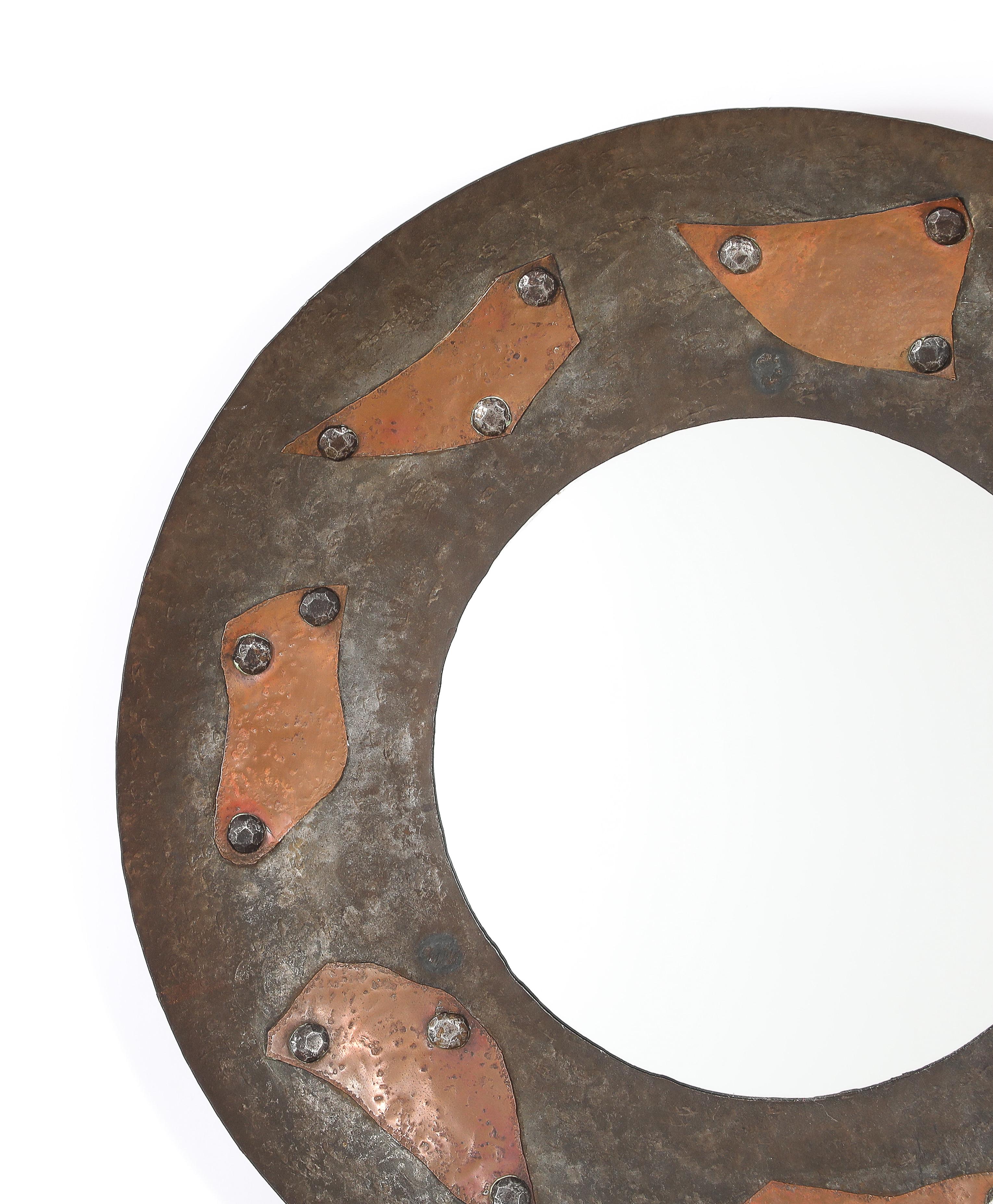 Round & Concave hammered steel mirror with added riveted copper motif.