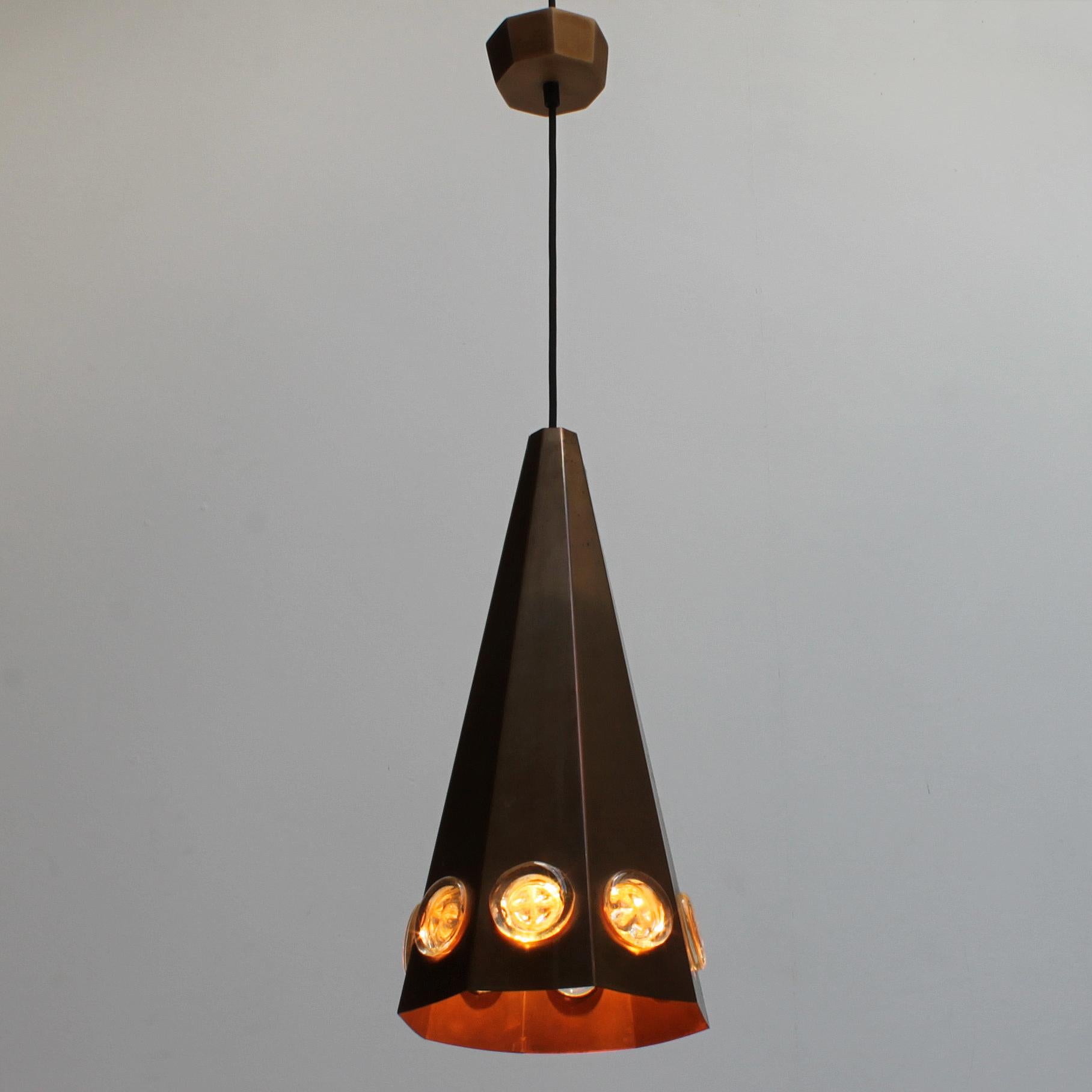 Brutalist Scandinavian pendant by Hans Bergström and Erik Hoglund for Ateljé Lyktan, Sweden. Conical shape in patinated copper and glass medallions. 
Dimensions fixture: height 18.1 inches (46 cm), diameter 8.7 inches (22 cm). From ceiling till