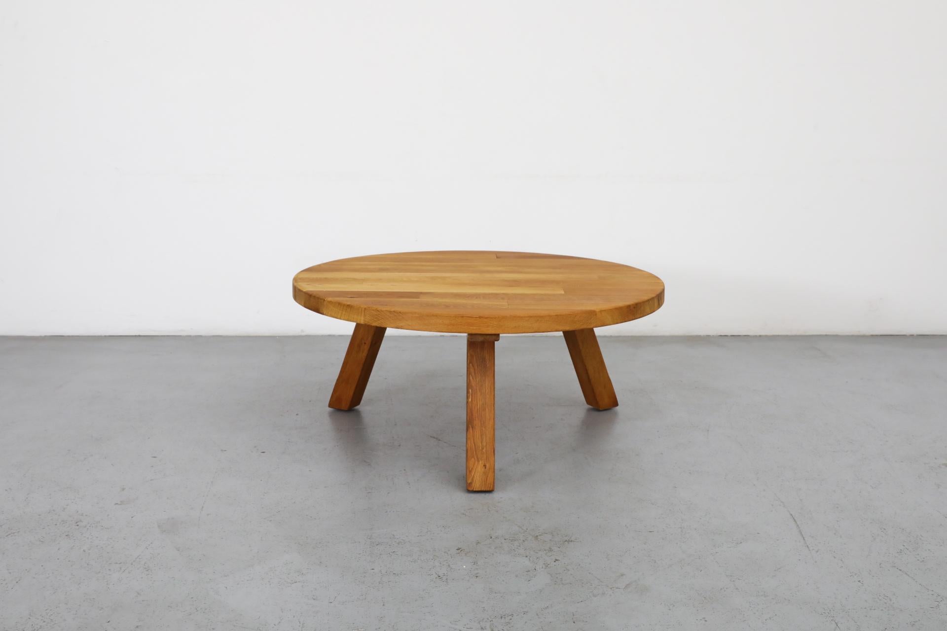 Brutalist Pierre Chapo inspired round coffee table made from solid oak with three angled square legs. In original condition with some visible wear and patina consistent with its age and use. Other similar tables available and listed separately.