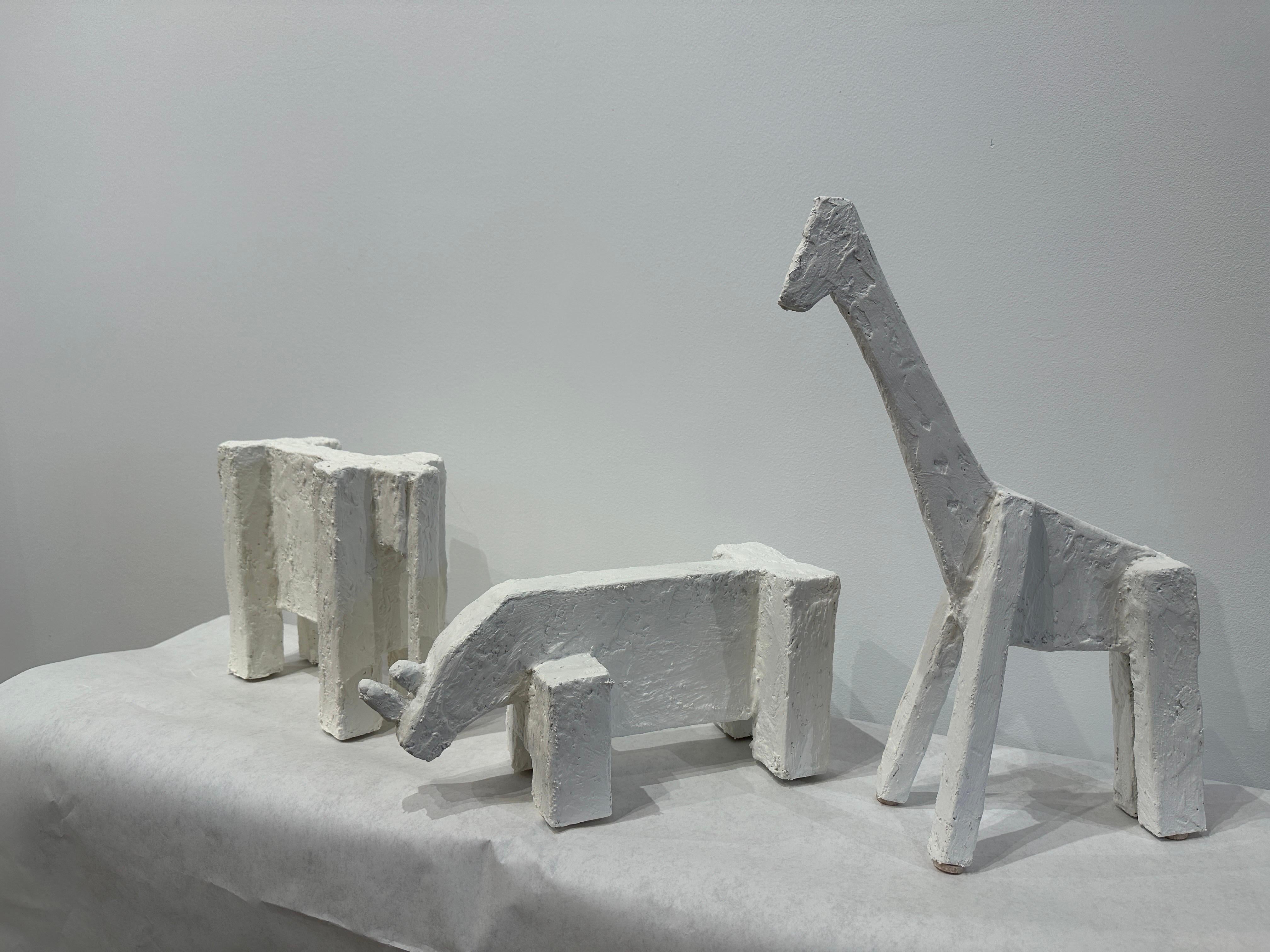 In the Cubist style, these whimsical plaster animal sculptures of a Giraffe, Elephant and Rhinoceros, are perfect elements for a shelf or console table. Pronounced textured finish in the style of Giacometti works. Note: sold as a grouping Only.