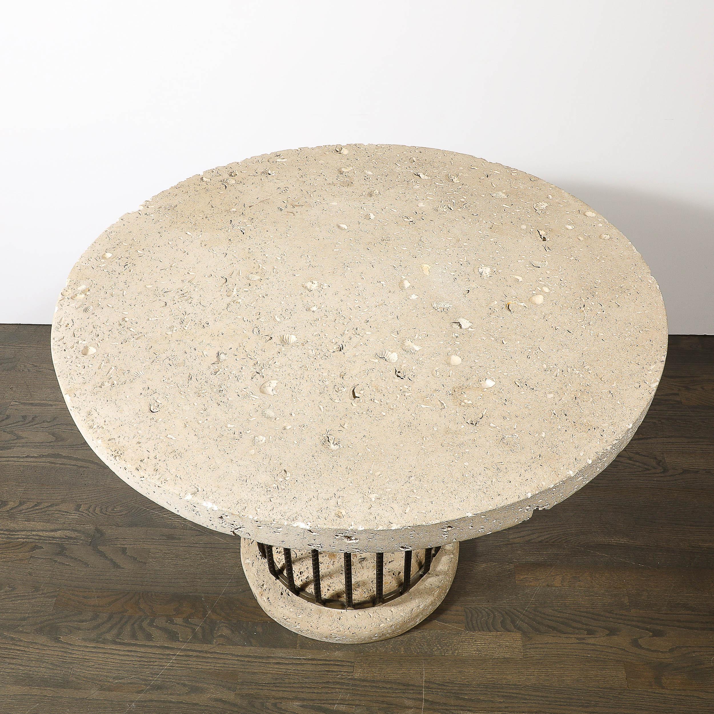 This substantial Brutalist Rebar and Fossilized Limestone Dining Table originates from the United States during the 20th Century. Features a rounded concrete base with an inset cylindrical support formed in vertically oriented rebar, with textural