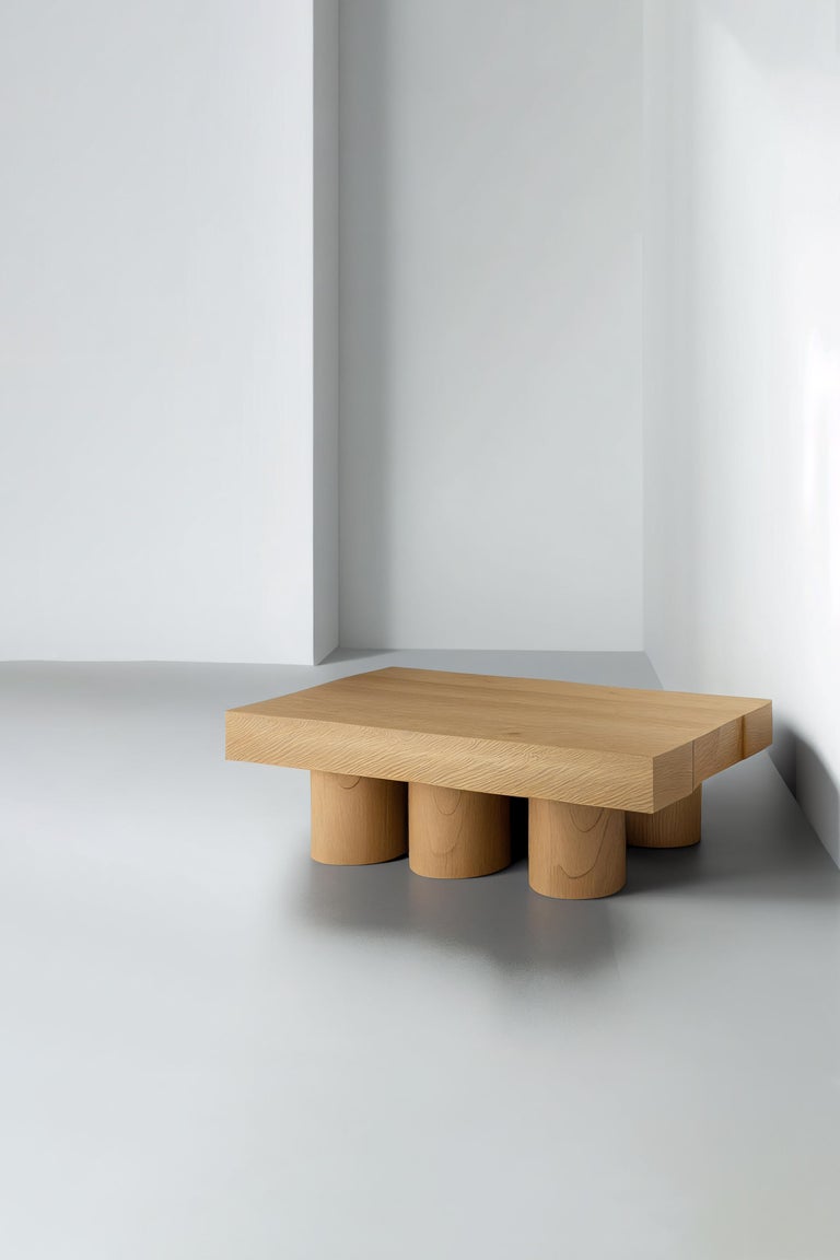 Brutalist rectangular coffee table in red oak wood veneer, Podio by NONO

The NONO design team presents a coffee table that exudes elegance and modernity. The foundation of this piece is a cluster of cylindrical columns, providing a sturdy base