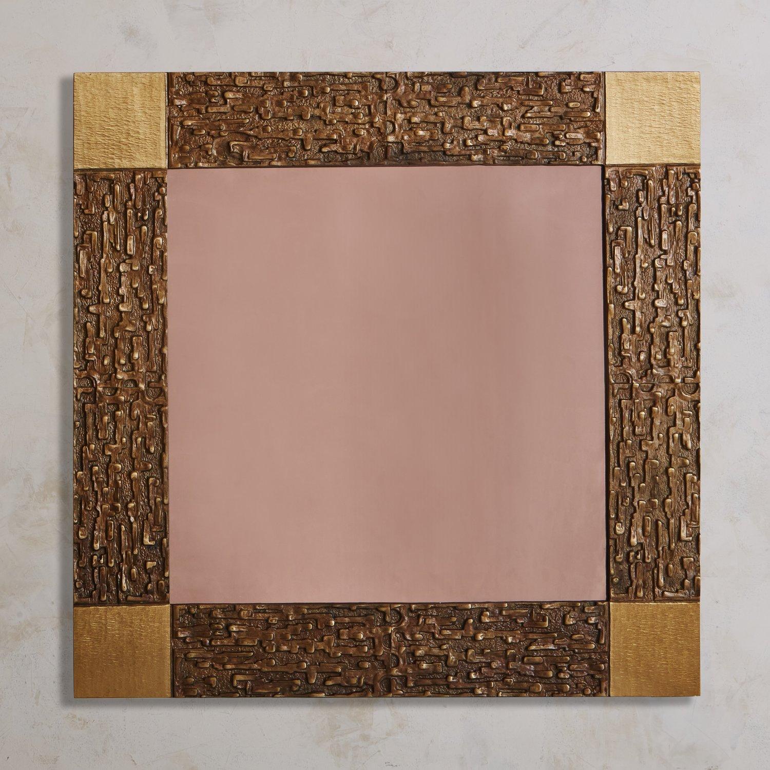A brutalist rose tinted wall mirror attributed to Luciano Frigerio. This mirror features a square patinated cast brass frame with a captivating textural finish and square corner details. Sourced in France, 1970s.

Luciano Frigerio (1928-1999) was