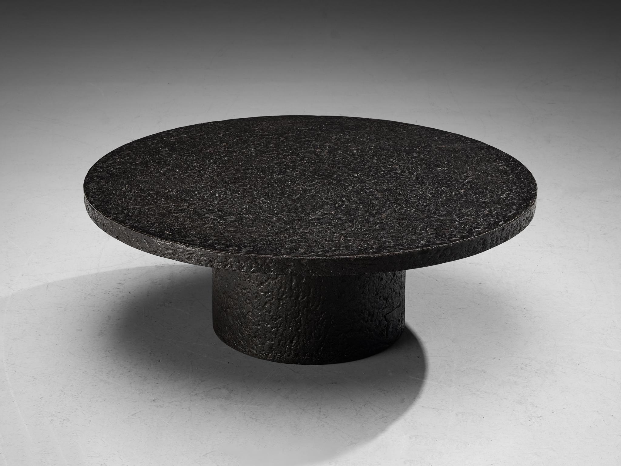 Cocktail table, resin, Northern-Europe, 1970s.

This deep black robust coffee or cocktail table is from the 1970s. The thick round top is supported by a similar but smaller round column. The whole construction is executed in resin which resembles