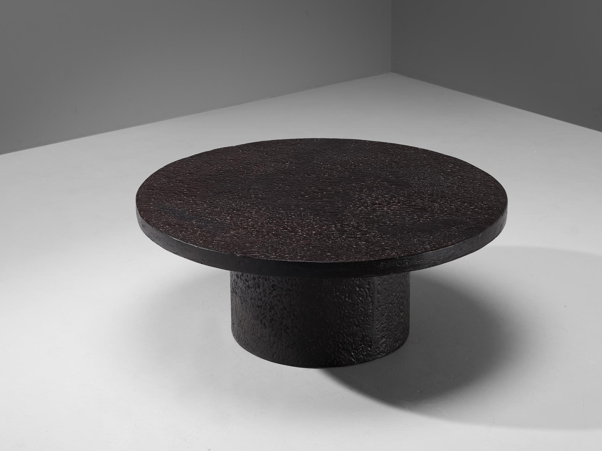 Cocktail table, resin, Northern-Europe, 1970s.

This deep black robust coffee or cocktail table is from the 1970s. The thick round top is supported by a similar but smaller round column. The whole construction is executed in resin which resembles