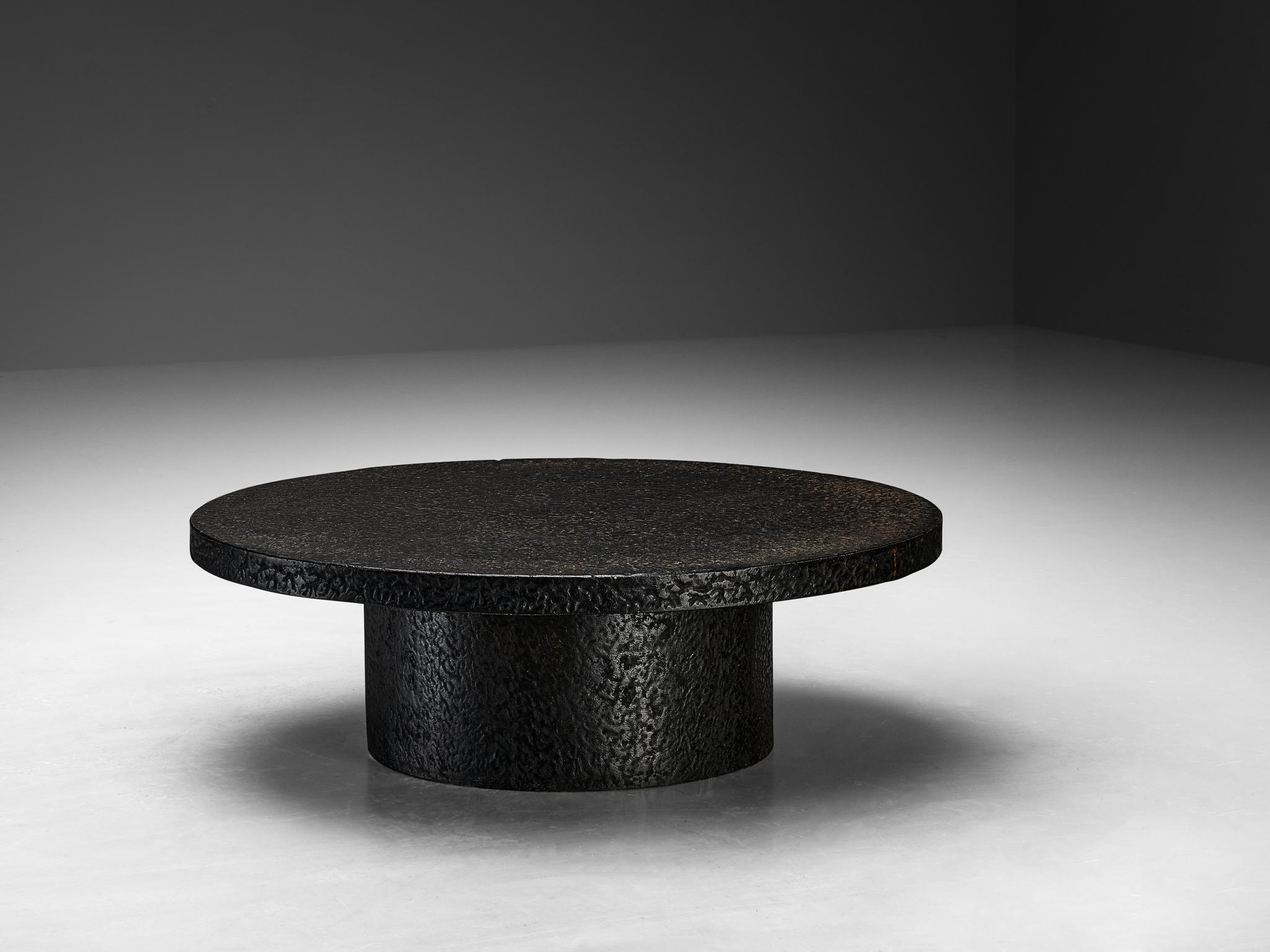 Cocktail table, resin, Northern-Europe, 1970s.

This deep black robust coffee or cocktail table is from the 1970s. The thick round top is supported by a similar but smaller round column. The whole construction is executed in resin which resembles