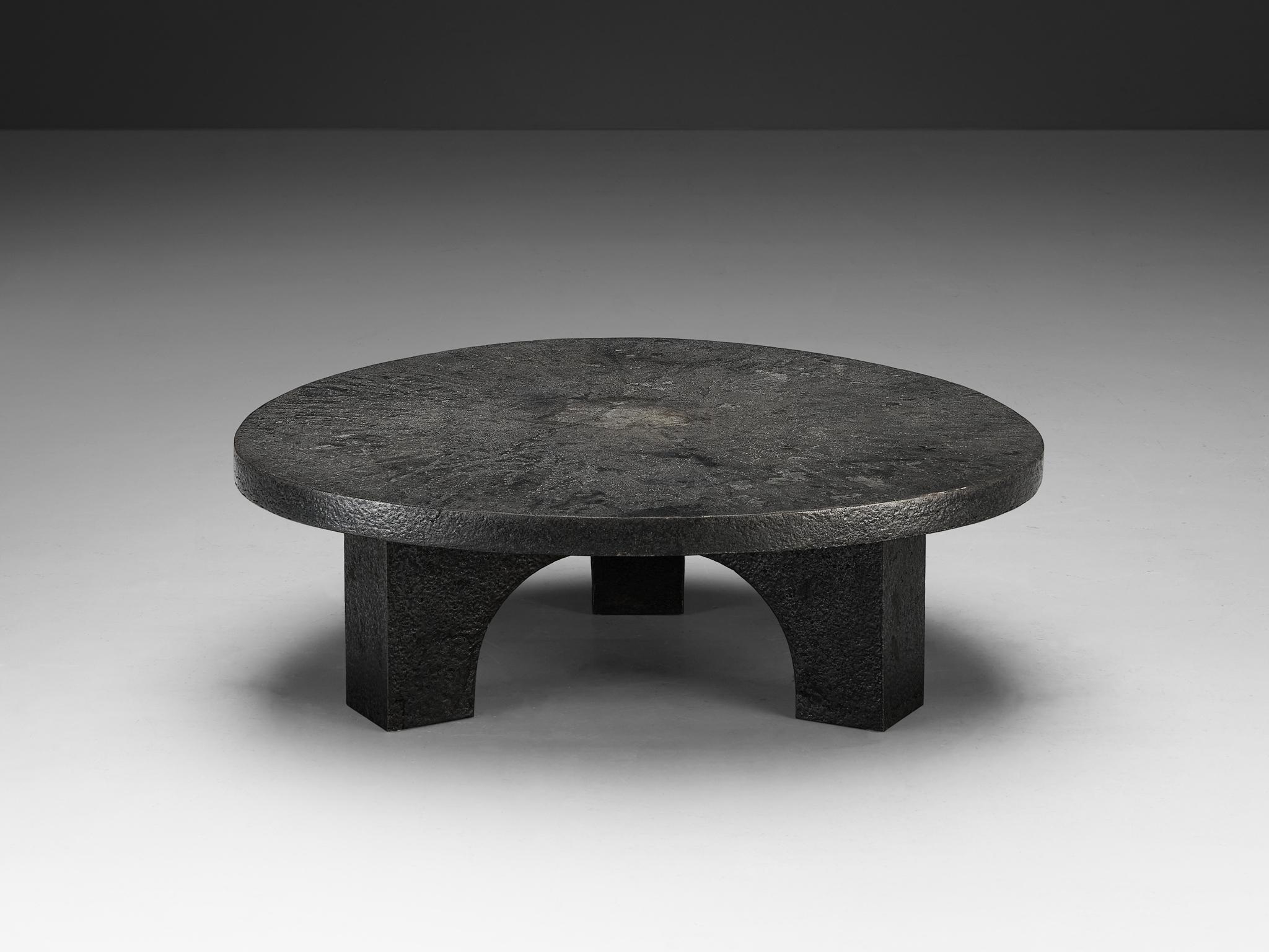 Cocktail table, resin, Northern-Europe, 1970s.

This deep grey robust coffee or cocktail table is from the 1970s. The thick round shaped top is supported by a smaller column with arched framework. The whole construction is executed in resin which