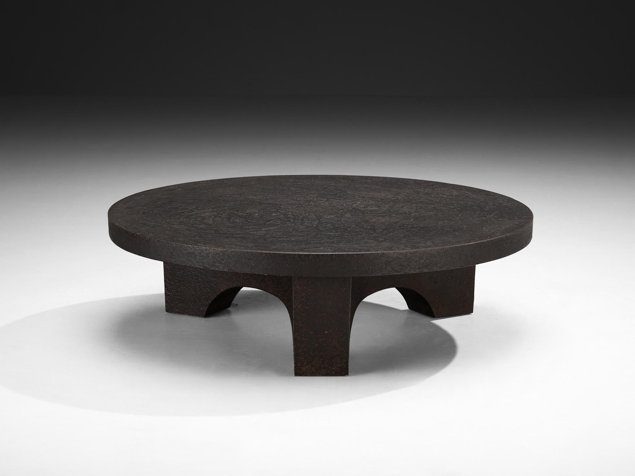 Cocktail table, resin, Northern-Europe, 1970s.

This deep black robust coffee or cocktail table is from the 1970s. The thick round shaped top is supported by a smaller column with arched framework. The whole construction is executed in resin which