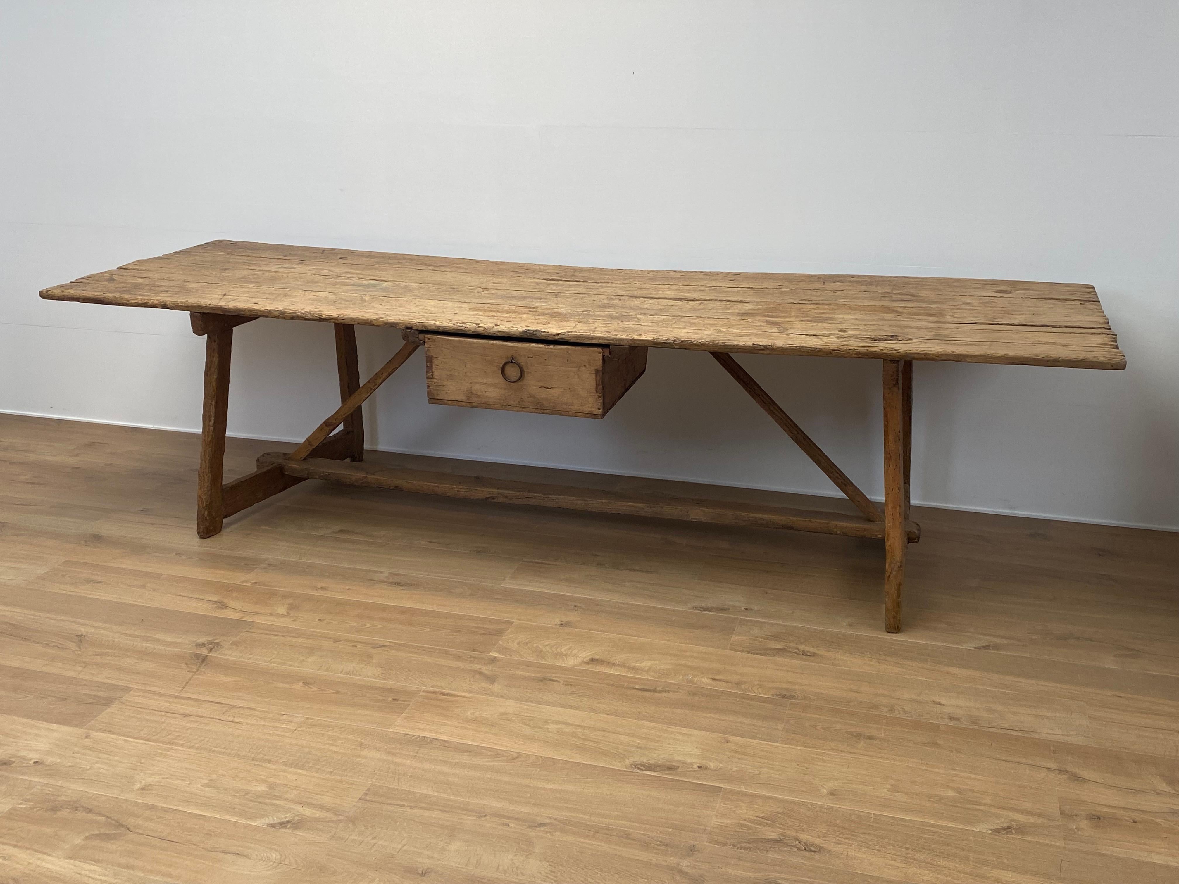 Rustic,Brutalist Spanish Farm table in a bleached Chestnut Wood,
the table comes from a Country house in the Catalan Regio of Girona,
very beautiful warm wear of the wood, great old genuine patina,
the table has one drawer in the center and shows