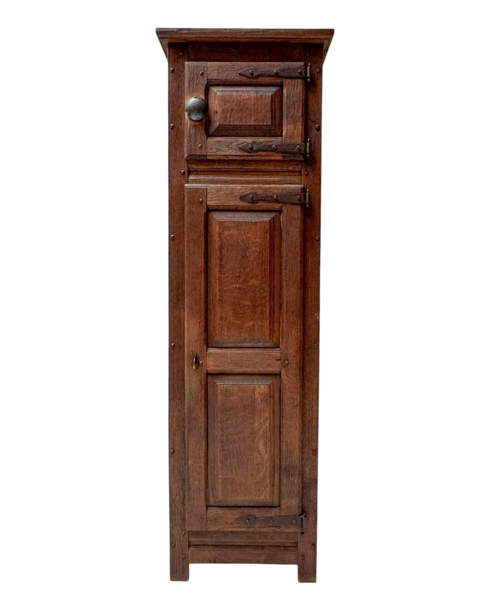 Stunning and primitive Brutalist Rustic Wabi Wabi cupboard.Striking Dutch design from the 1970s.Solid oak base with original iron hinges and two doors.Seven original oak shelves.Lock and key are in good working order.This wonderful Brutalist Rustic
