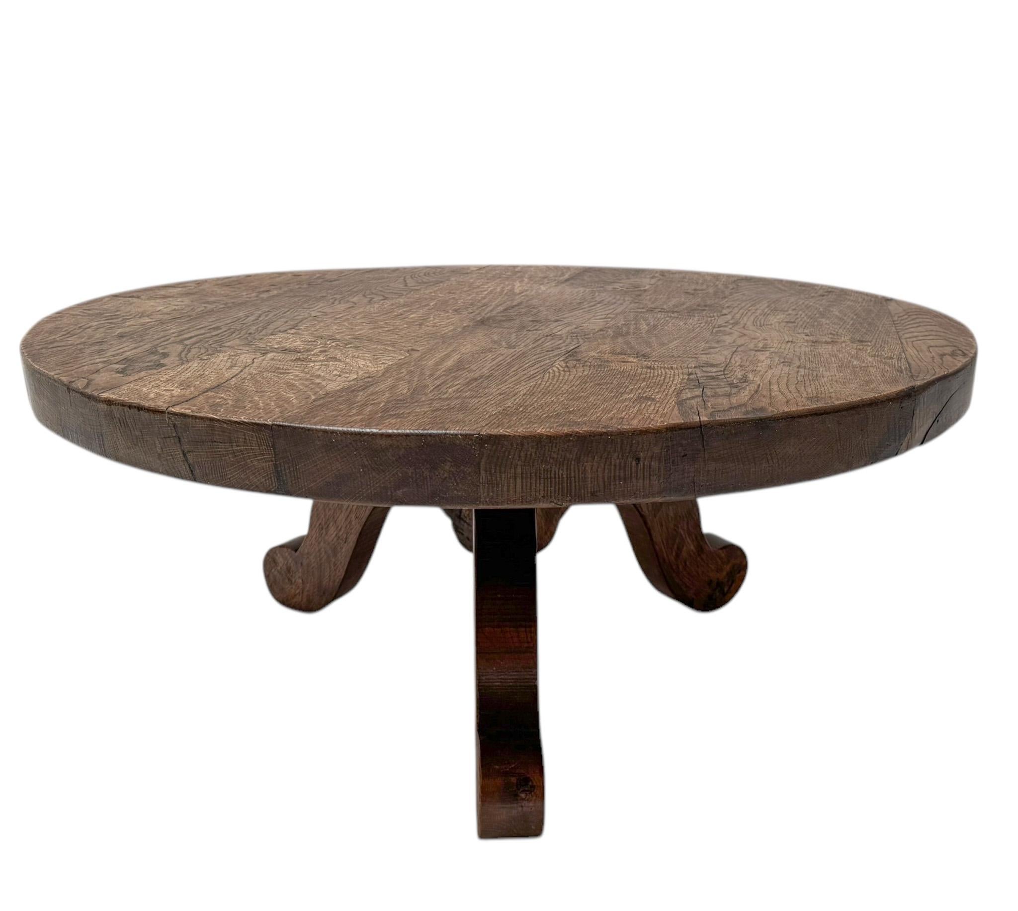 Stunning and elegant Brutalist Rustic Wabi Sabi round coffee table.Striking Dutch design from the 1970s.Solid oak three-legged base with original solid patinated oak round top.This wonderful Brutalist Rustic Wabi Sabi round coffee table is in good