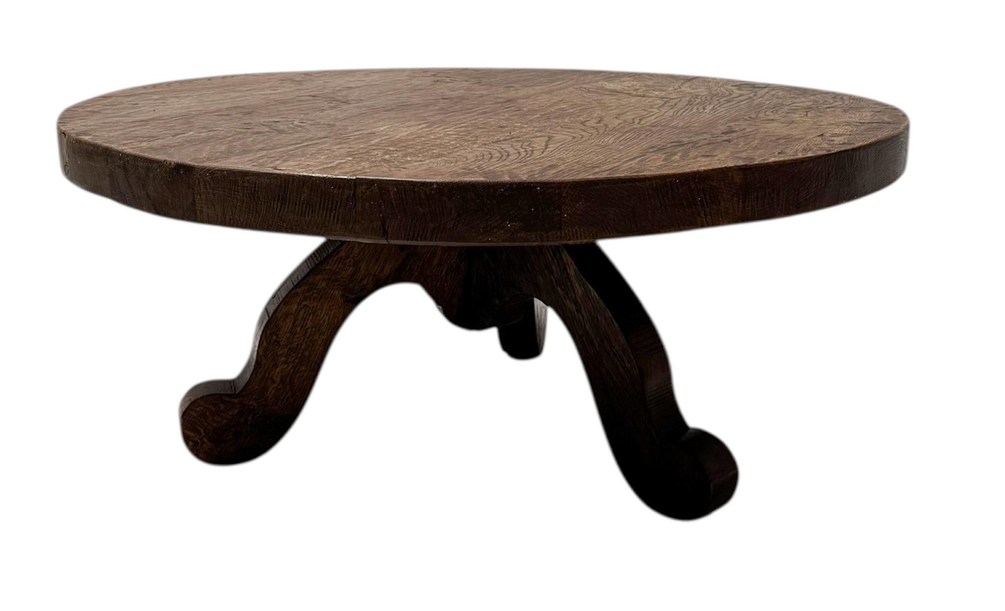 Stunning and elegant Brutalist Rustic Wabi Sabi round coffee table.Striking Dutch design from the 1970s.Solid oak three-legged base with original solid patinated oak round top.This wonderful Brutalist Rustic Wabi Sabi round coffee table is in good