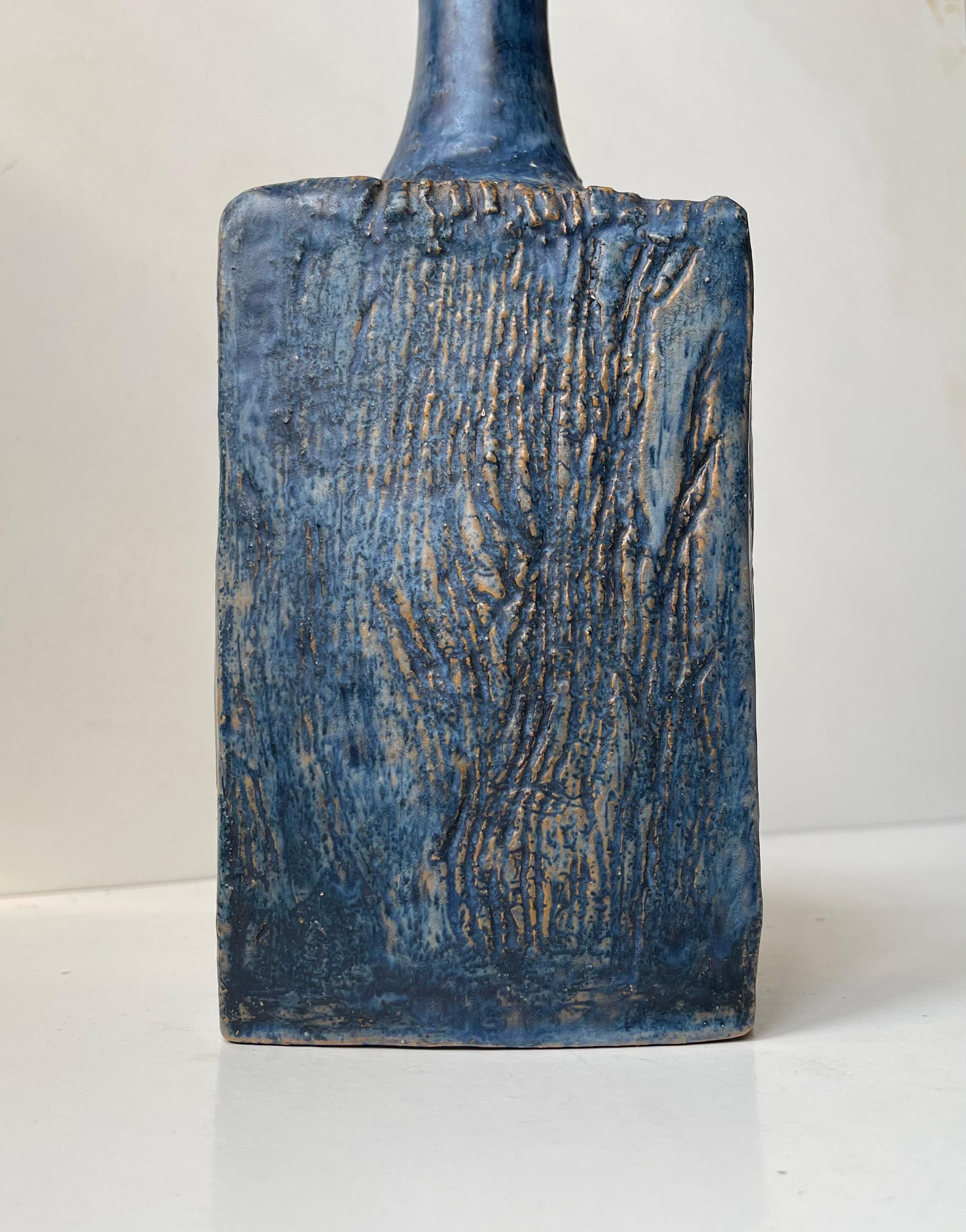Large and special Scandinavian vase executed in glazed stoneware. It is square and features incised patterns and finished with a denim blue glaze. Un-known Scandinavian/Danish maker with close resemblance to designs by Finn Lynggaard and Annikki
