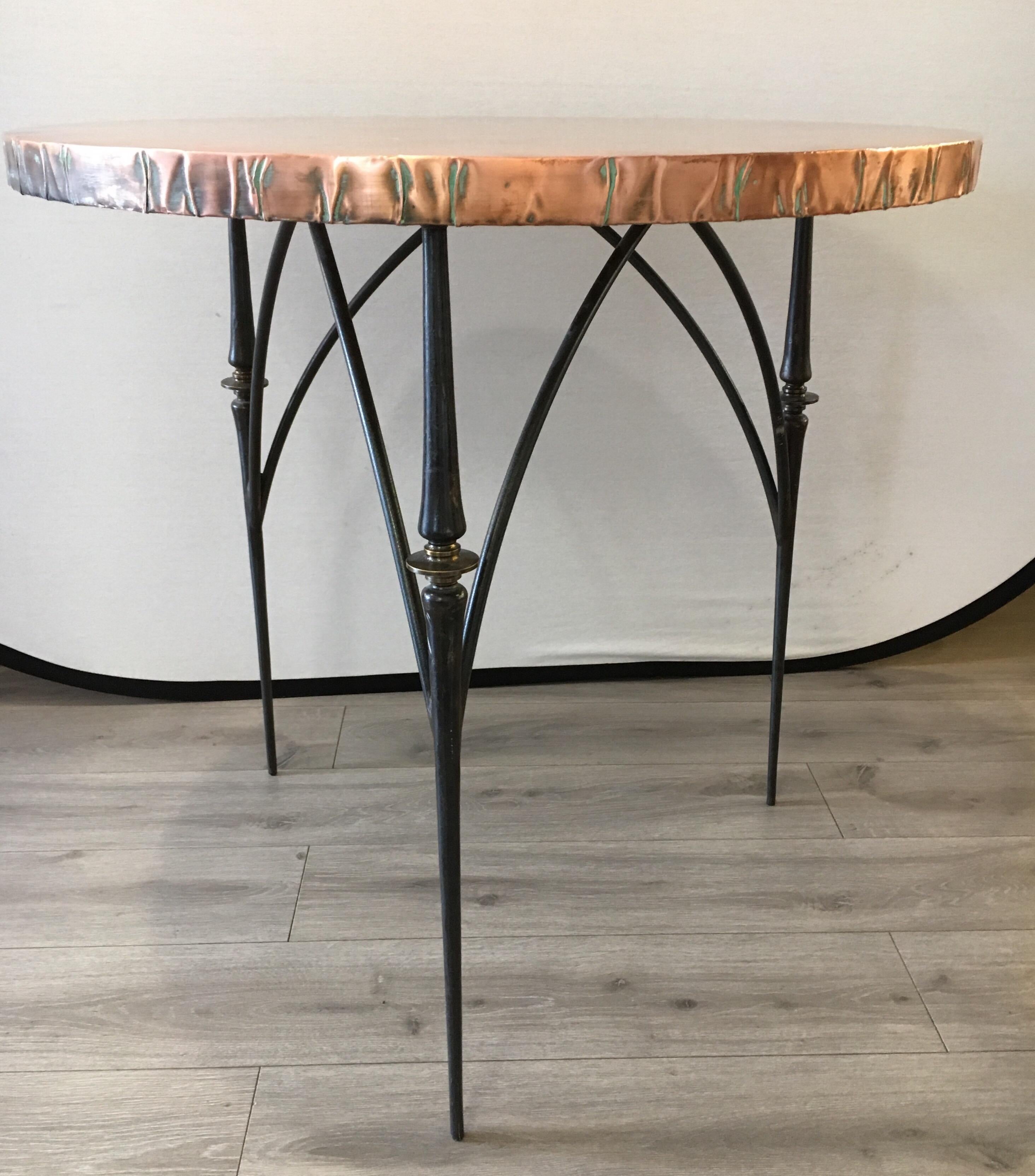 Bespoke foyer or center table that can also be used as a small dining table. In the style of some of the best studio furniture of designers like Paul Evans, this piece has the elemental presence of a modern sculpture. From afar the hammered copper