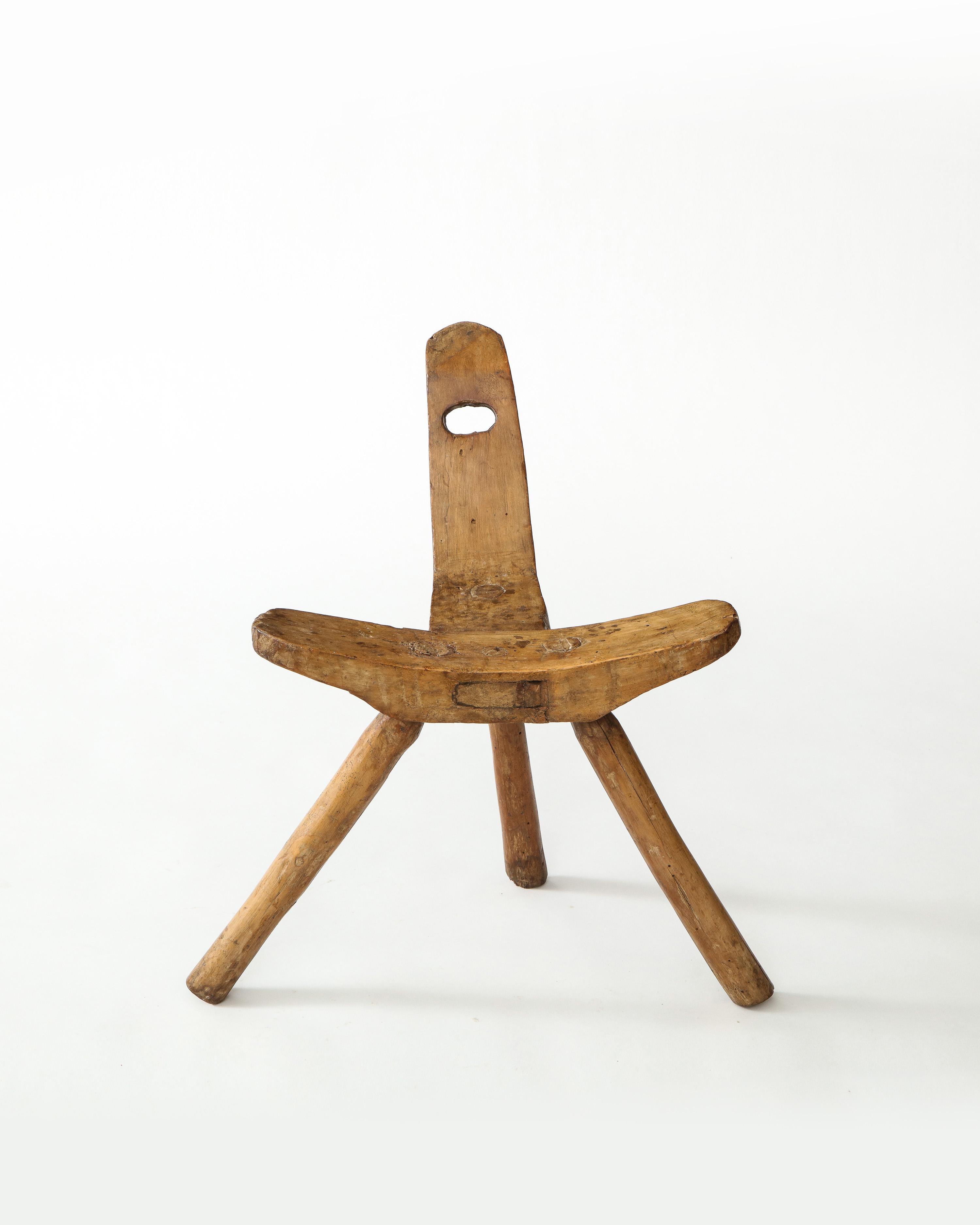 Three-legged Brutalist wooden stool. Back and seat are both composed of large pieces of solid elm. Cool open handle detail. Quite amazing to behold from all vantage points.