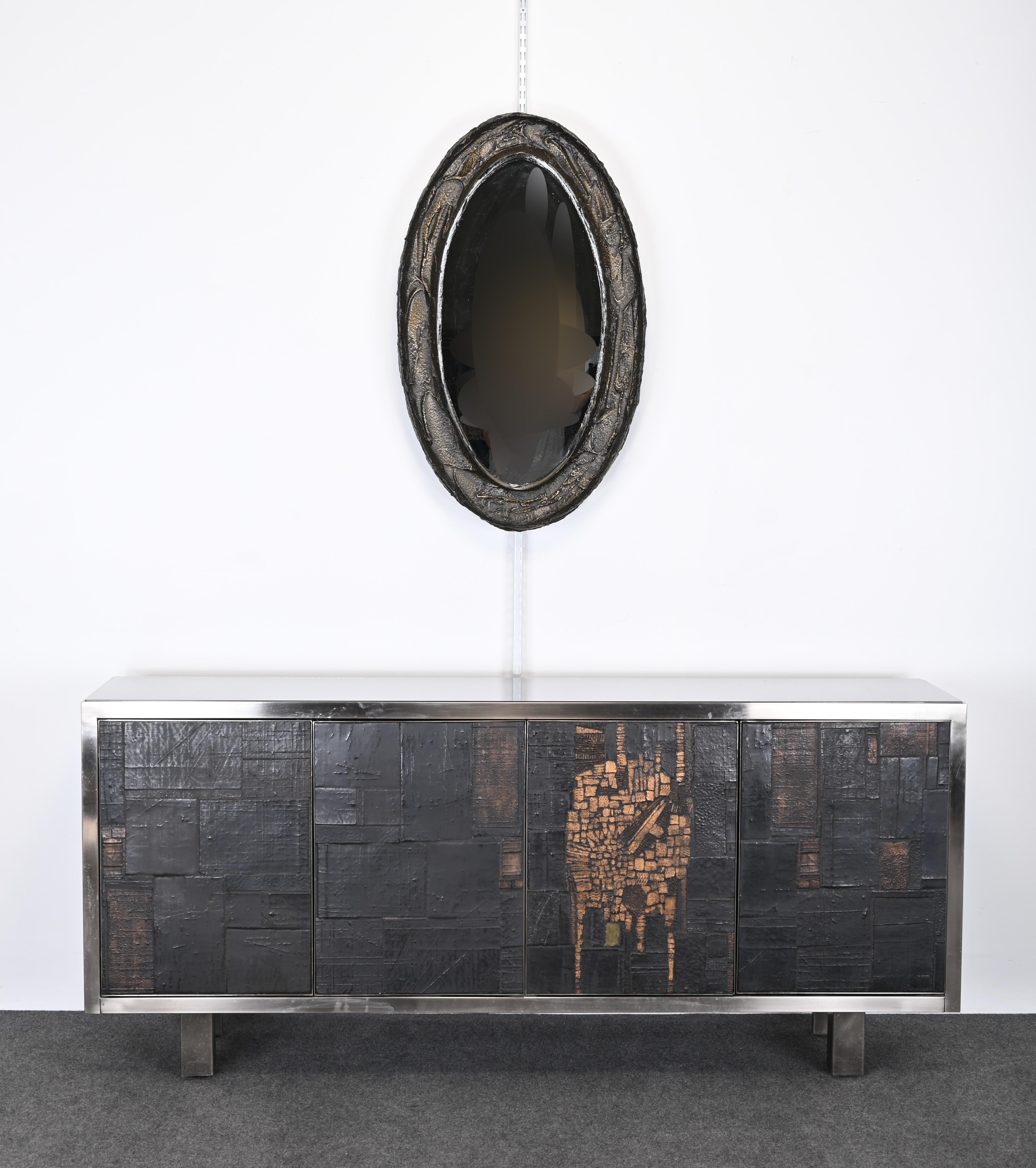 A Brutalist or Le Brutalisme sculpted bronze resin Wall Mirror by Paul Evans. The decorative mirror would look great in any Mid-Century Modern or Contemporary interior decorated with Brutalist furniture from the Mid-20th Century.  The sculpted