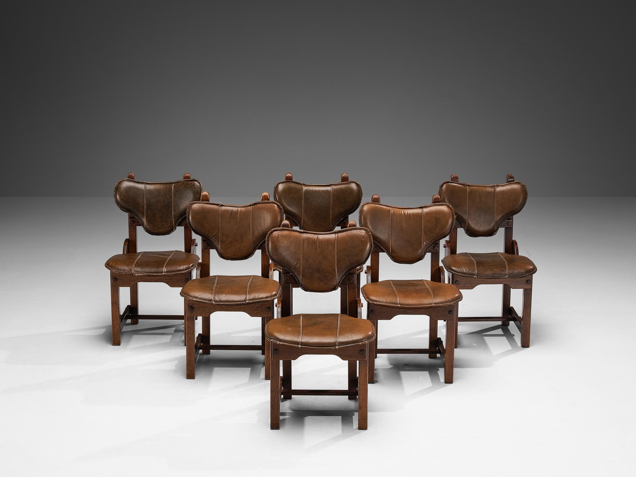 Set of six dining chairs, oak, leather, The Netherlands, 1960s

Distinctive set of chairs with a brutalist look composed of sturdy shapes and contrasting play of lines. The backrest captivates the eye by means of the triangle-shaped form with
