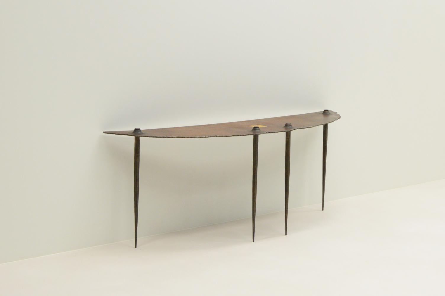 Brutalist side table by Idir Mecibah for Smederij Moerman, 1990s Belgium. This side table is part of the Scrab series. Made of forged steel. In the center is a gold leaf square. Idir died at a young age and most of his designs aren’t produced