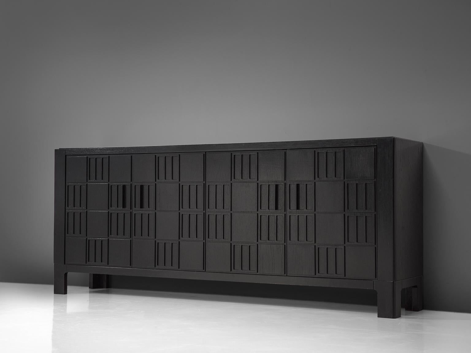 Brutalist sideboard, black stained wood, Europe, 1970s. 

This modern and clean sideboard with 4-door panels is executed with a soficticated pattern of squares. One of the many beautiful details is, that this pattern transforms into the four
