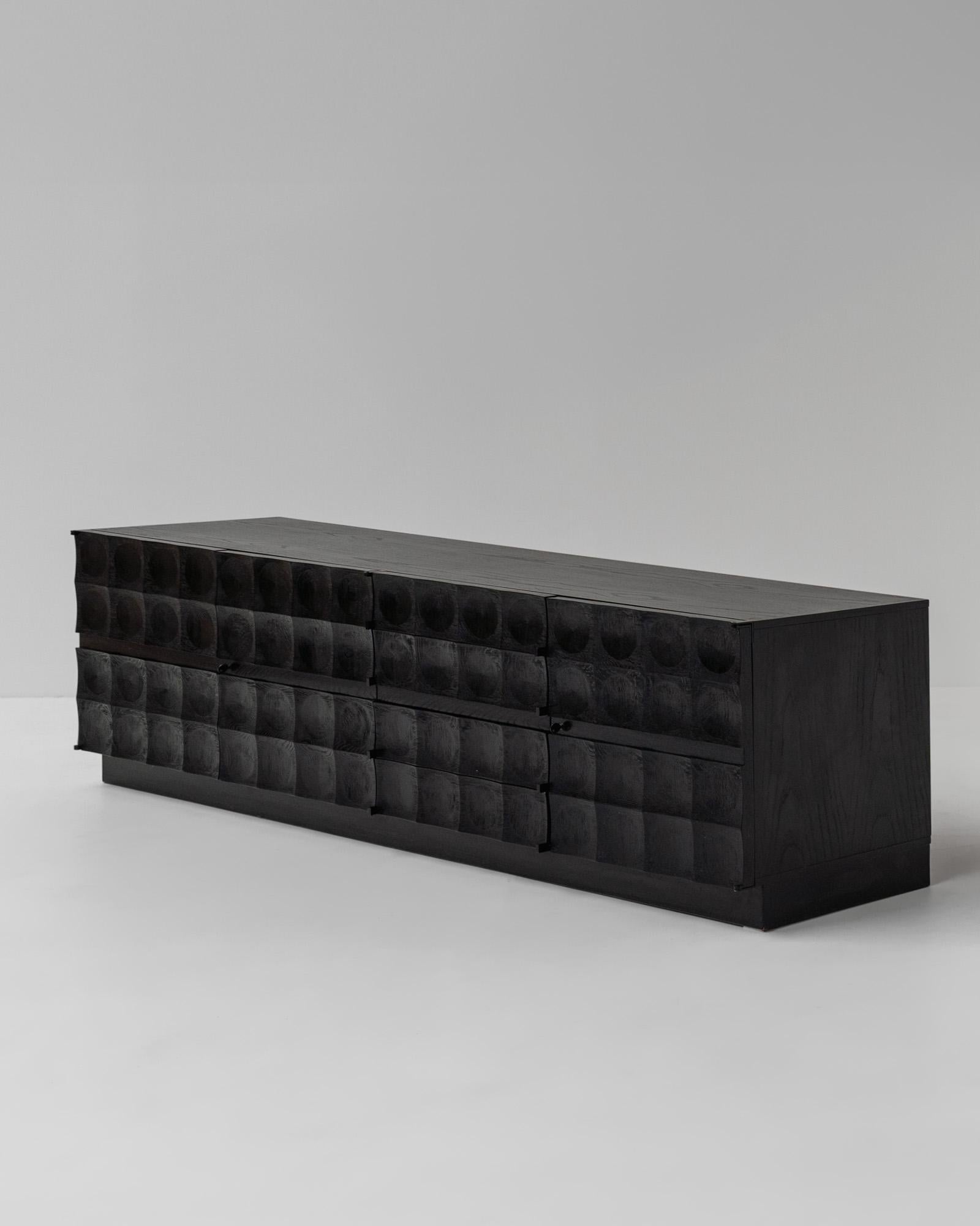 Impressive graphic, brutalist-style design credenza, Belgium

Because of its dimensions and the beautiful sculptured doors, it beats all the other sideboards. The woodwork is out of this world, and the matte black finish gives an intriguing vibe to