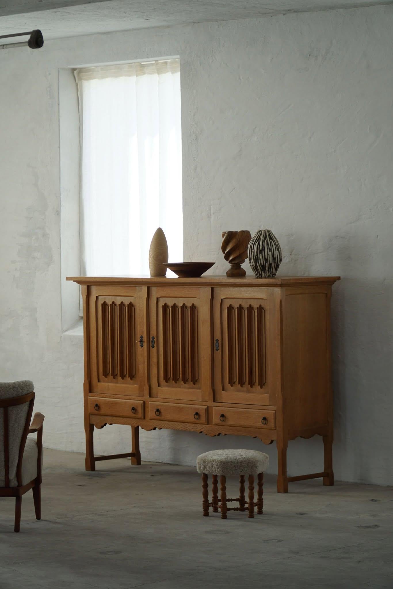 A fantastic classic sideboard in oak with a sculptural front design. Made by a Danish Cabinetmaker in the 1960s. This piece is in a good vintage condition, with few traces of wear.

This brutalist object will fit into many interior styles. A Modern,
