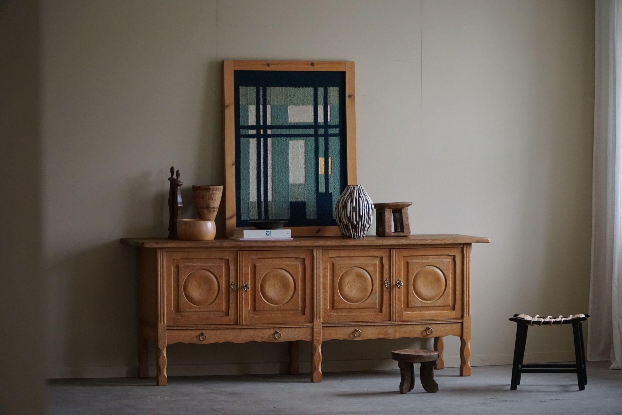 A fantastic low classic sideboard in solid oak. Made by a Danish Cabinetmaker, Anker Sørensen in the 1960s. This piece is in a good vintage condition, with few traces of wear.

This brutalist object will fit into many interior styles. A Modern,