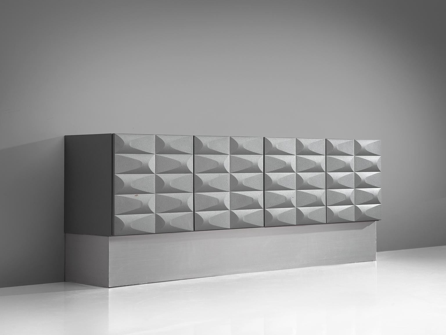 Brutalist credenza, wood and aluminum, European, 1970s. 

Modern and clean two-door sideboard. Two door panels, each with an exceptional three-dimensional pattern executed in a soft grey tone. The continuous pattern gives this bar-cabinet a very