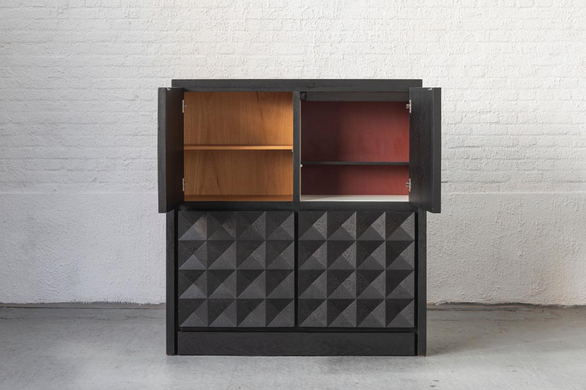 Brutalist sideboard in style of De Coene, produced in Belgium in the 1970s. A dark stained, wooden sideboard with sculptural door panels. The square shape resonates in the design, making it a very graphical piece. It features 4 cabinet compartments,