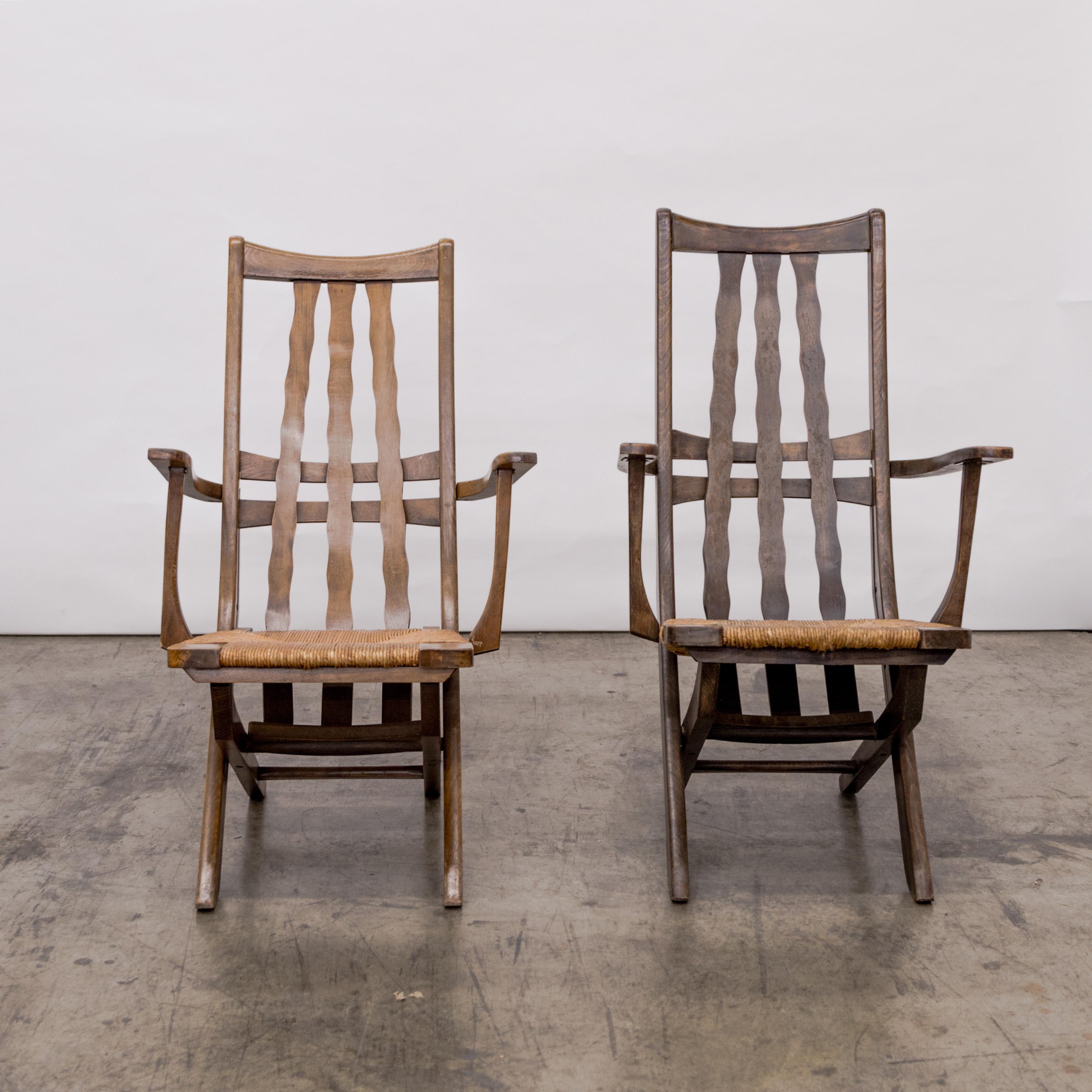 Brutalist pair of oak slat high back adjustable armchairs with rush seats, France circa 1950's.