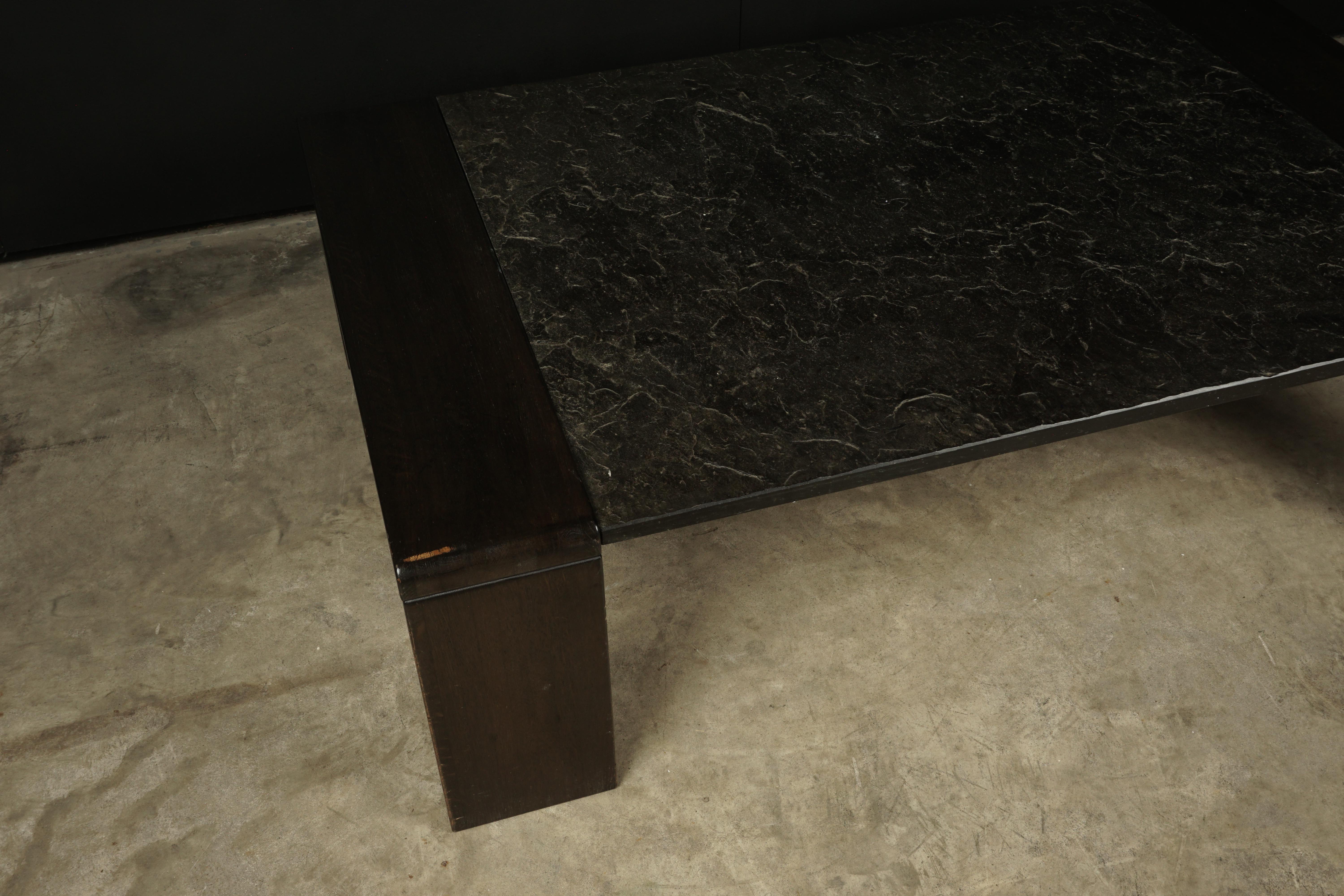 Brutalist slate coffee table from Holland, 1960s. Charcoal solid grey slate top on a wood base. Nice light wear and patina.