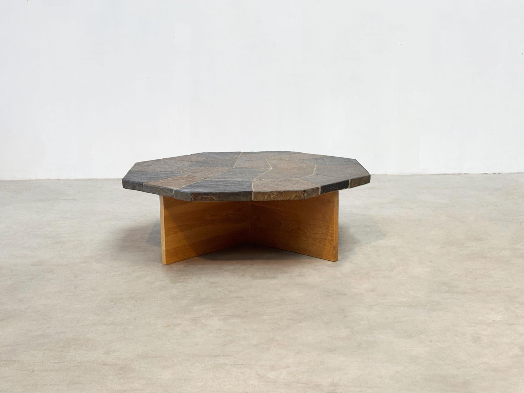 This 1980s brutalist coffee table from Germany features a striking oak cross frame with mosaic tiles on top. Its elegant base softens the bold design, making it less overwhelming while still commanding attention. The table bears a strong resemblance