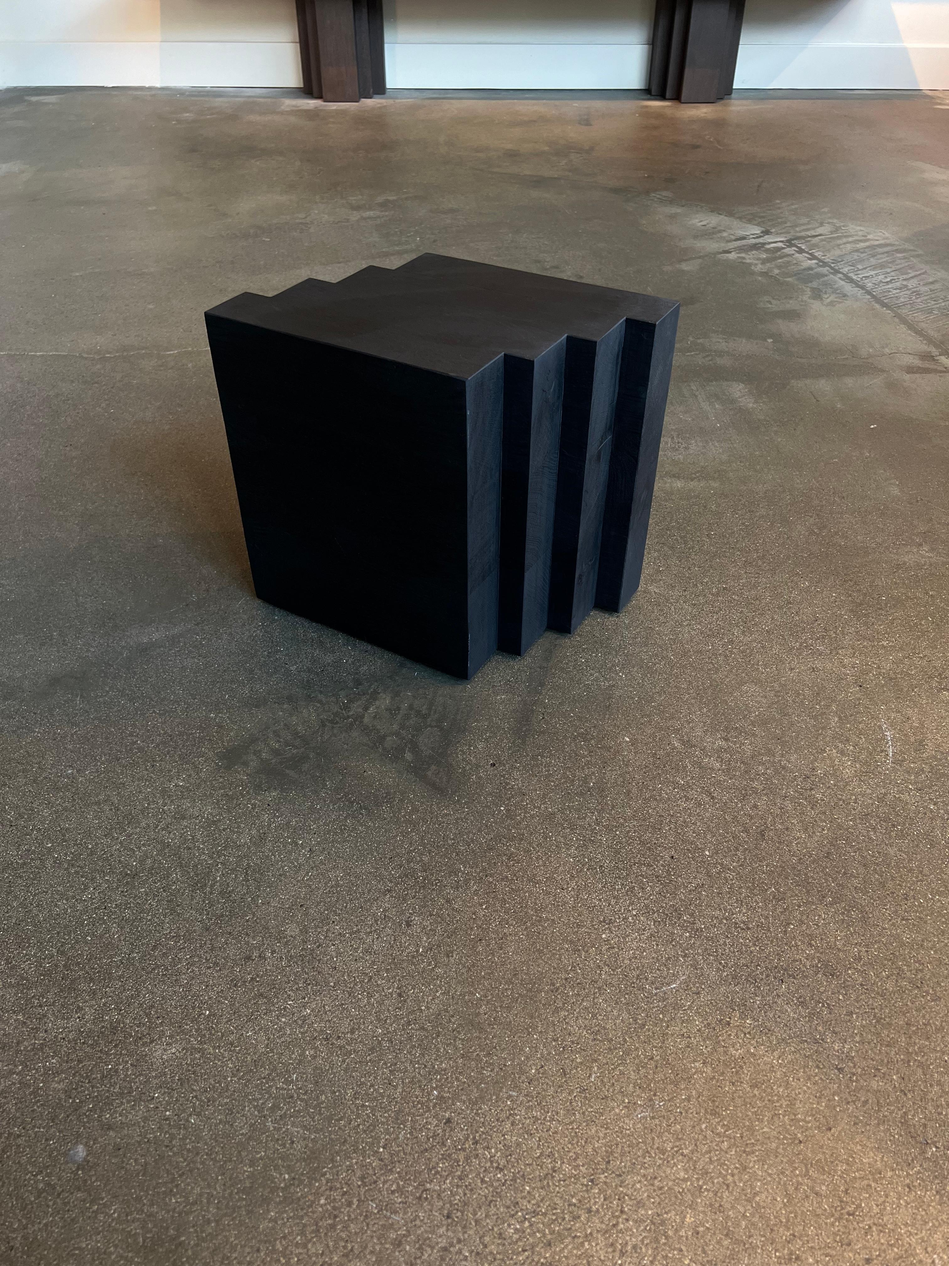 This solid oak Cadence side table is a showroom model in excellent condition. 
- Dimensions: L:34 x W:22 x H:30 cm. 
- The price includes a custom wooden shipping crate. 
- The thick solid wooden beams may contain small knots and cracks; these