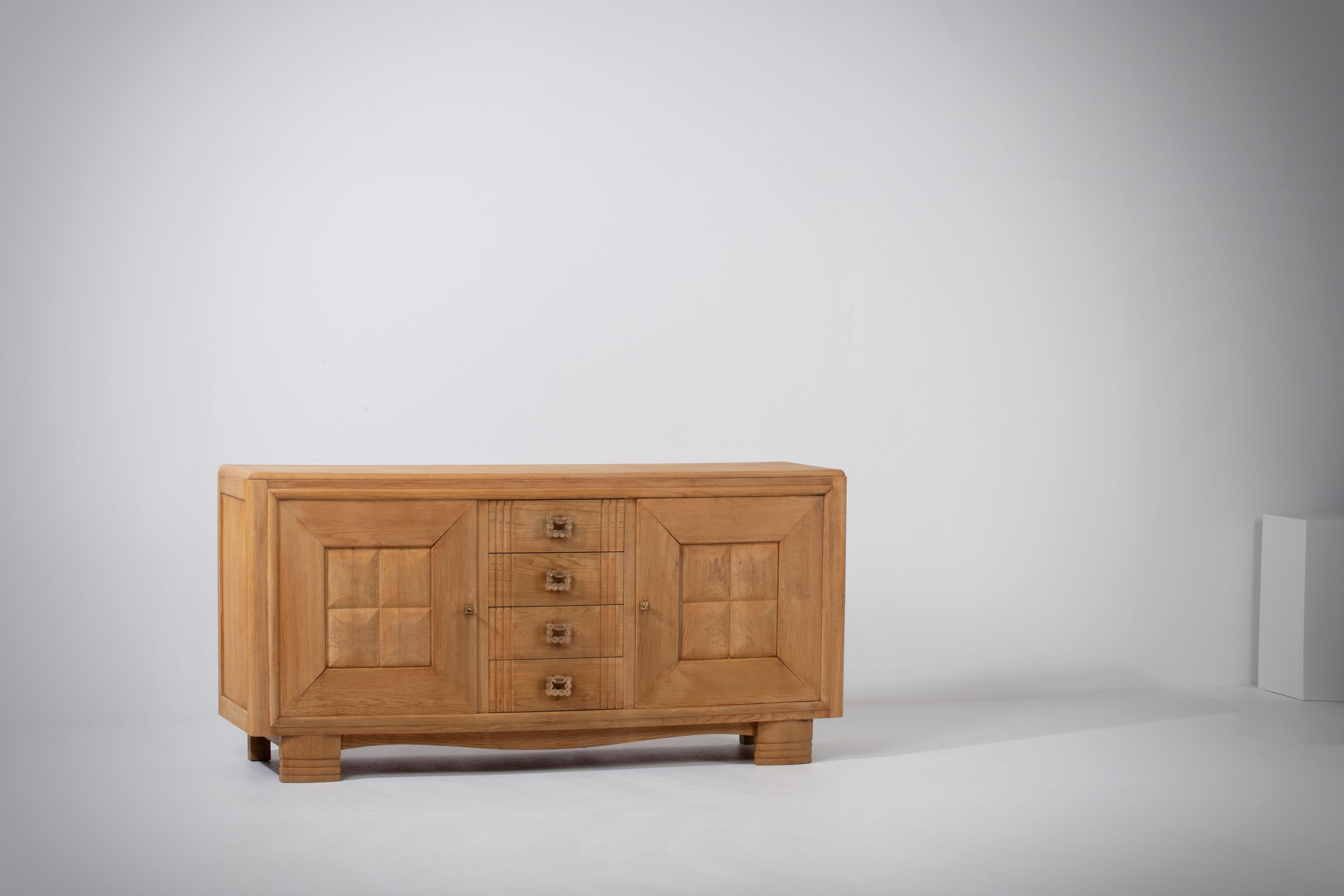 Introducing an exquisite sideboard crafted from natural oak, showcasing the beauty of its rich and warm tones. This remarkable piece exudes elegance and sophistication, reflecting the meticulous French craftsmanship that went into its
