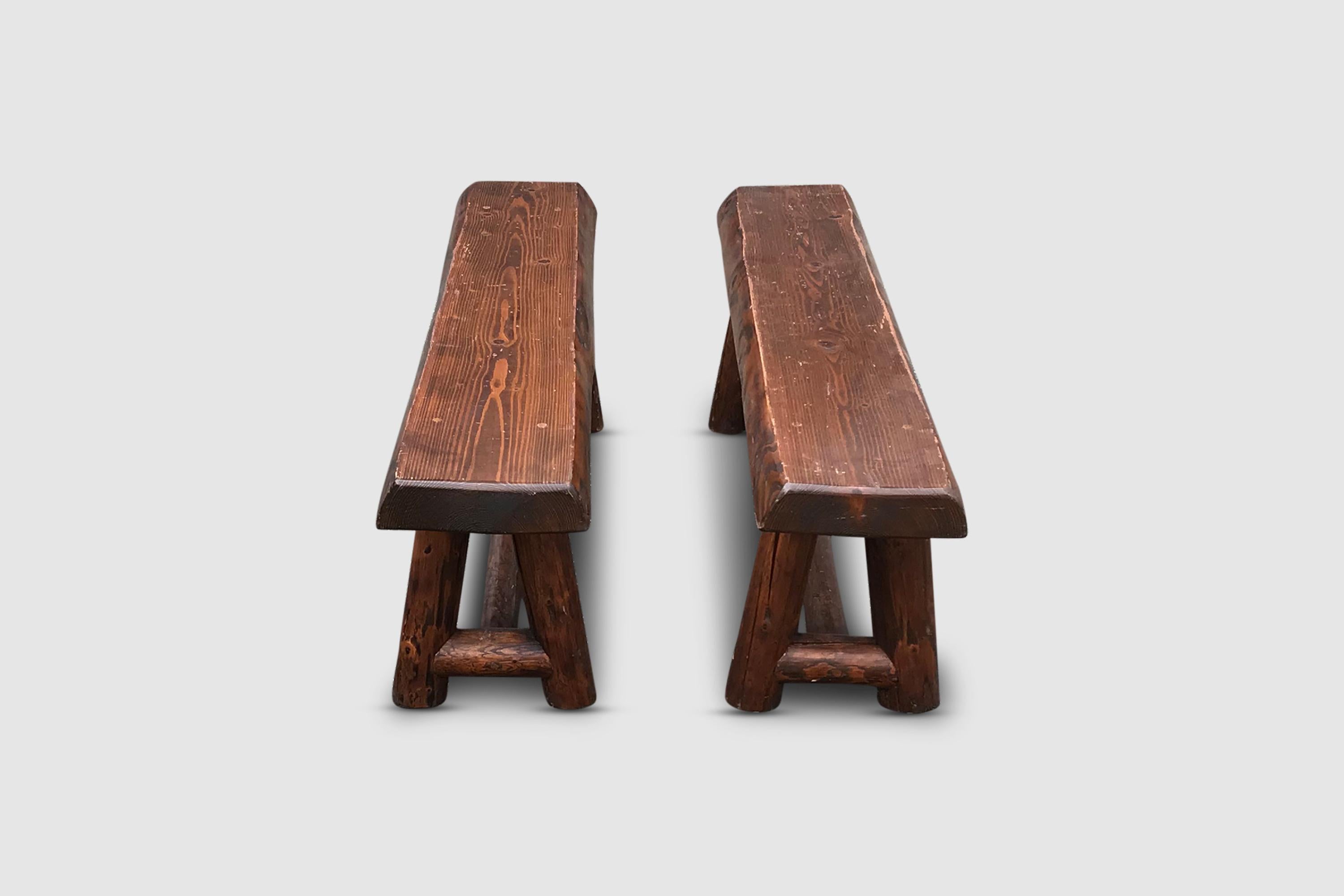 Set of oak benches with an interesting geometry of the feet. Constructed in solid oak with veneered brown color.

The top is constructed in a geometry, with rounded of edges, in the manner of Charlotte Perriand.

The feet are cilinder shaped and