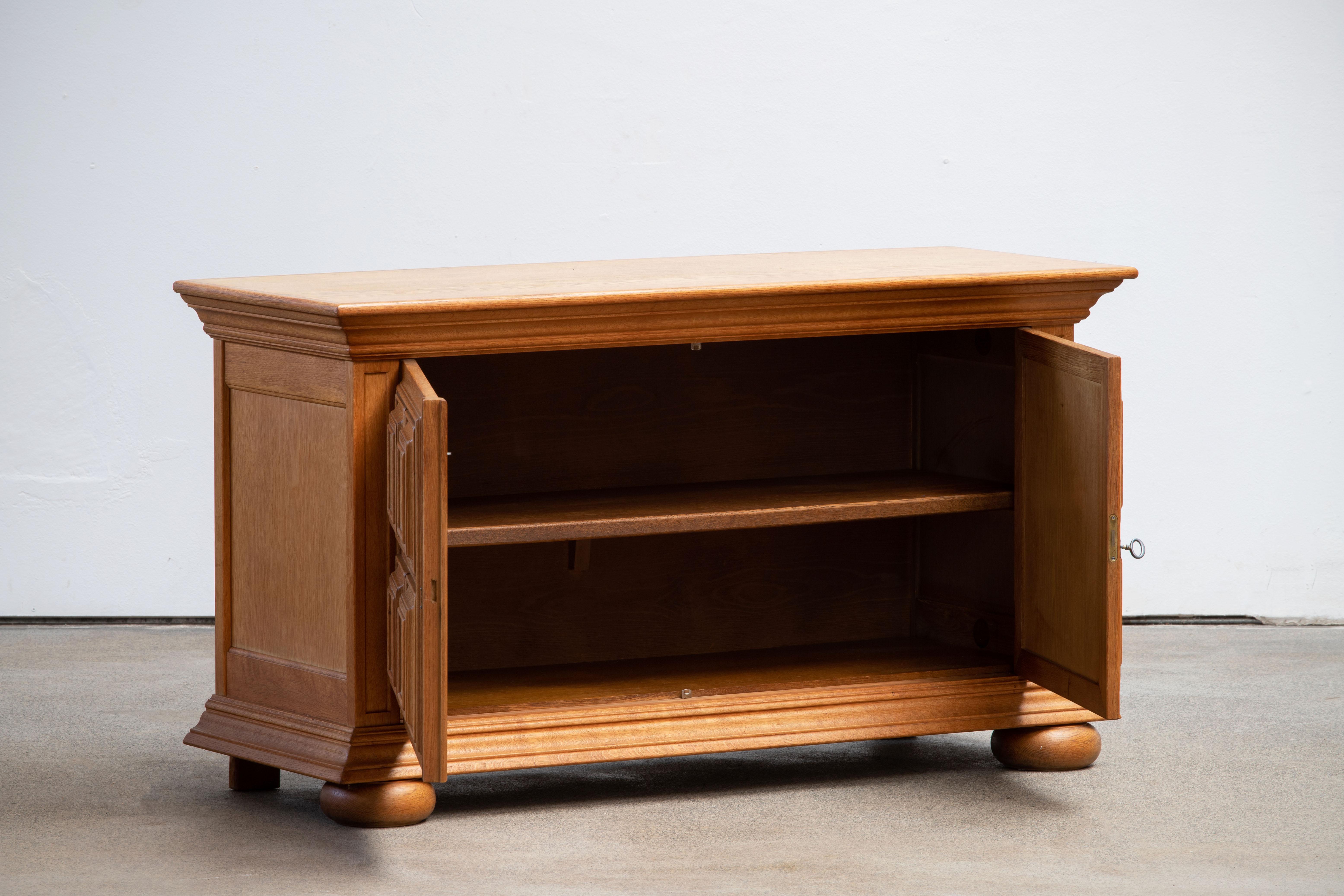 Brutalist solid oak sideboard, credenza, Spanish Colonial. The buffet features stunning Oak structure on door panels. It offers ample storage, with shelve behind the doors. A unique blend of Art Deco Spanish and Brutalist Modern design. The