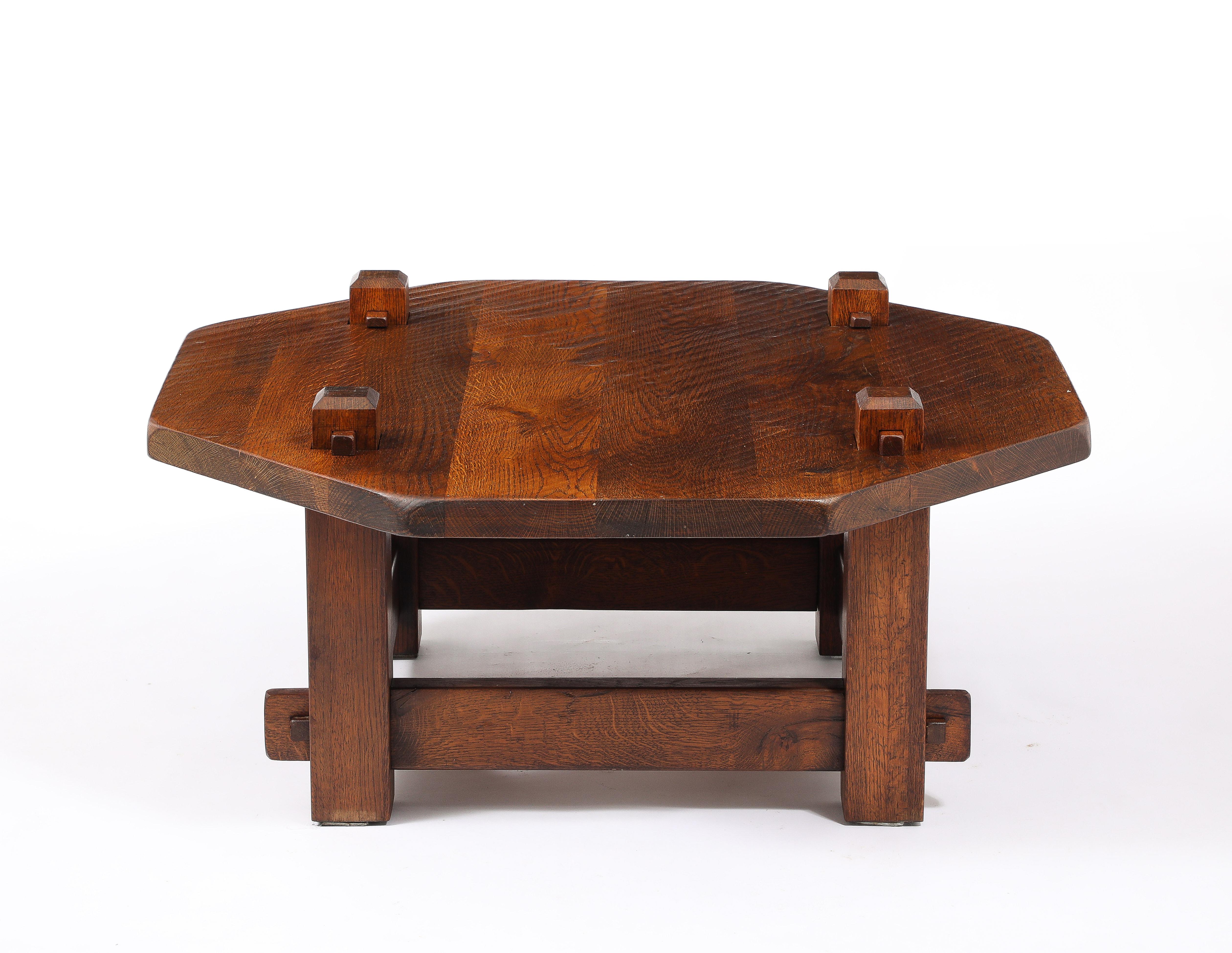 Large octagonal table entirely held together by a tongue and key system, made of solid oak with a deep patina