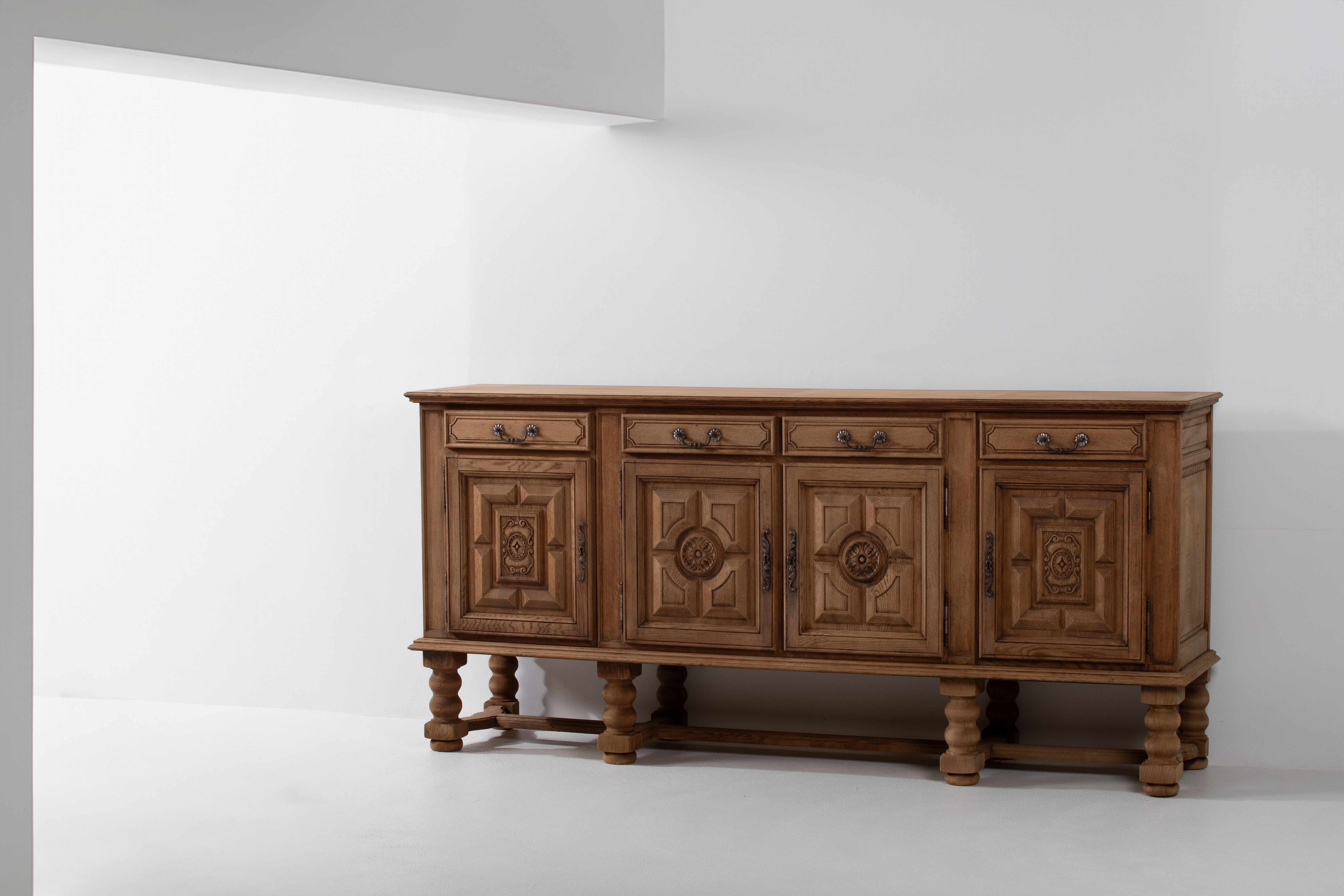 Indulge your senses in the grandeur of this remarkable 2.49-meter-long sideboard, a testament to the rich heritage of Spanish Brutalist inspiration. Crafted from solid oak, the tactile experience of the wood under your fingertips reveals the