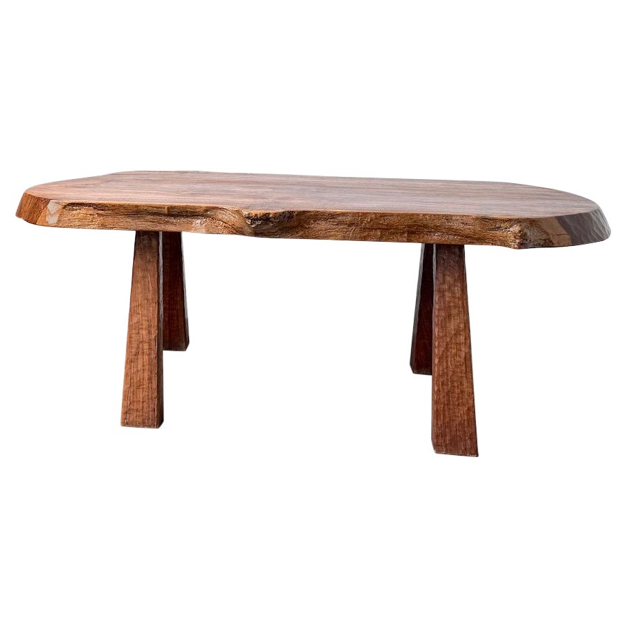 Brutalist solid walnut coffee table, France, 1970s. For Sale