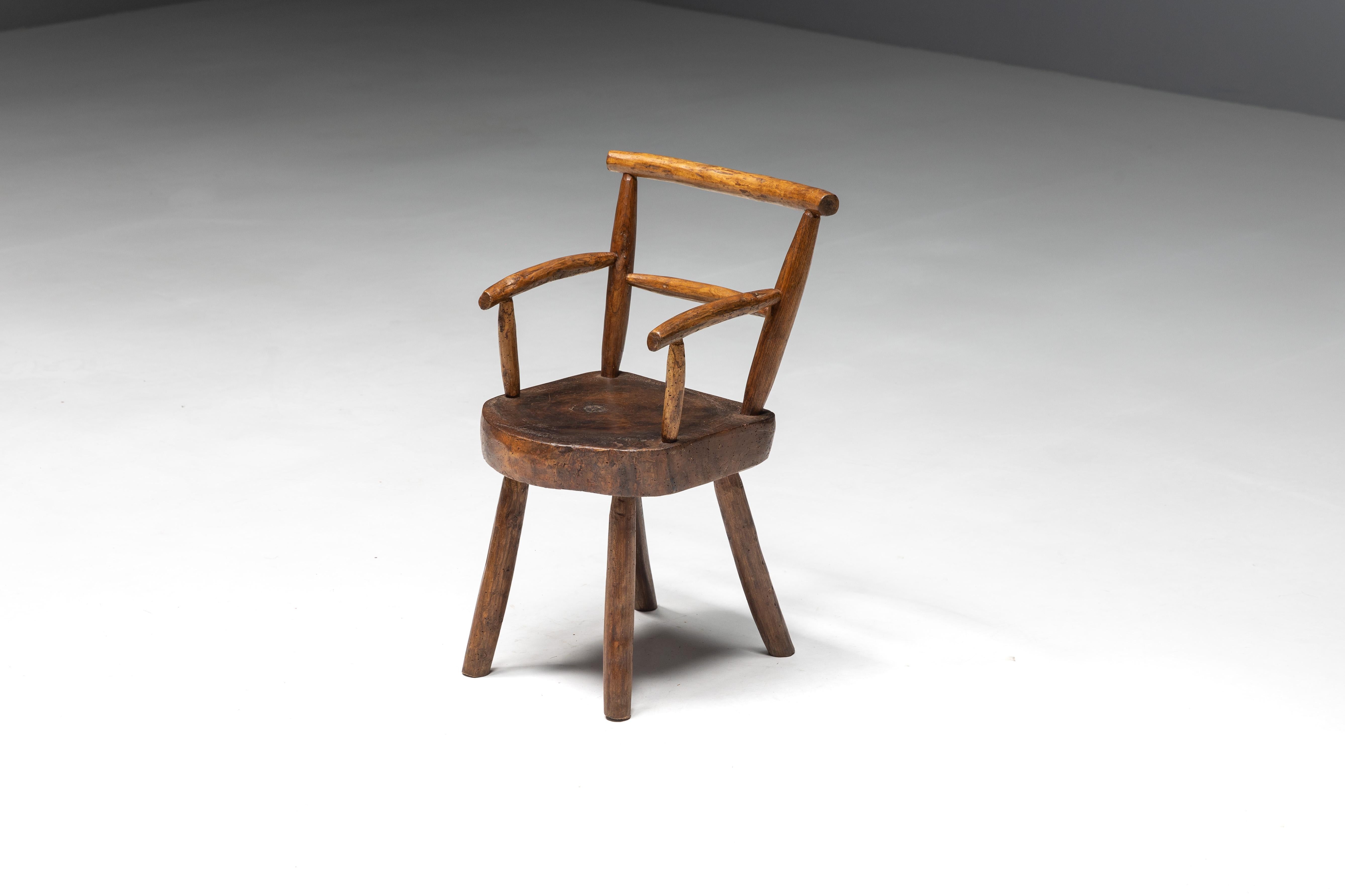 Brutalist child's armchair in solid wood, a captivating piece from 1960s France that embodies the 
