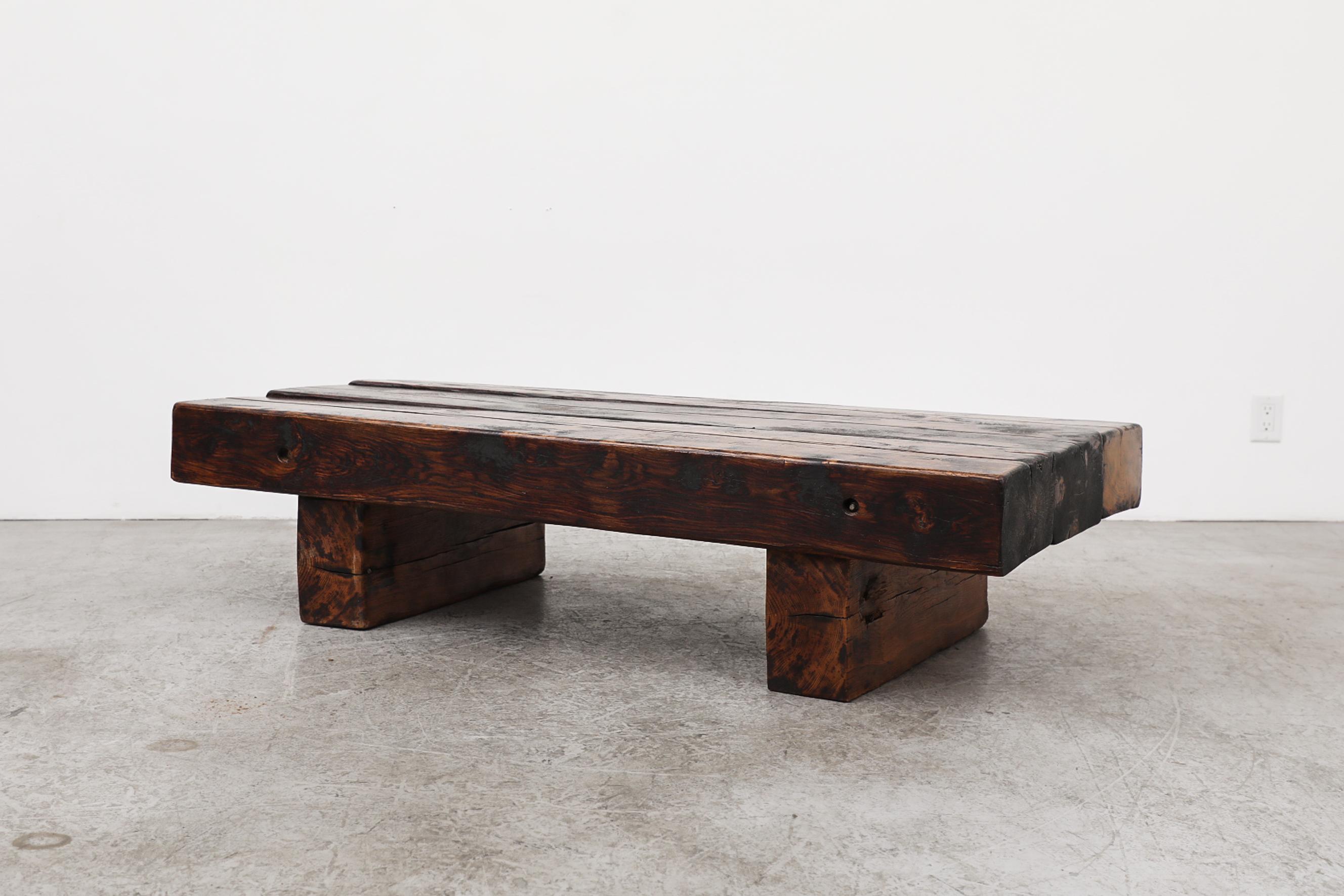 Mid-century Brutalist vintage coffee table made from extremely heavy rich dark wood, possibly iron wood or African hardwood, The table is designed in the style of the classic railroad tie coffee tables. The heavy table top sits unattached on the two
