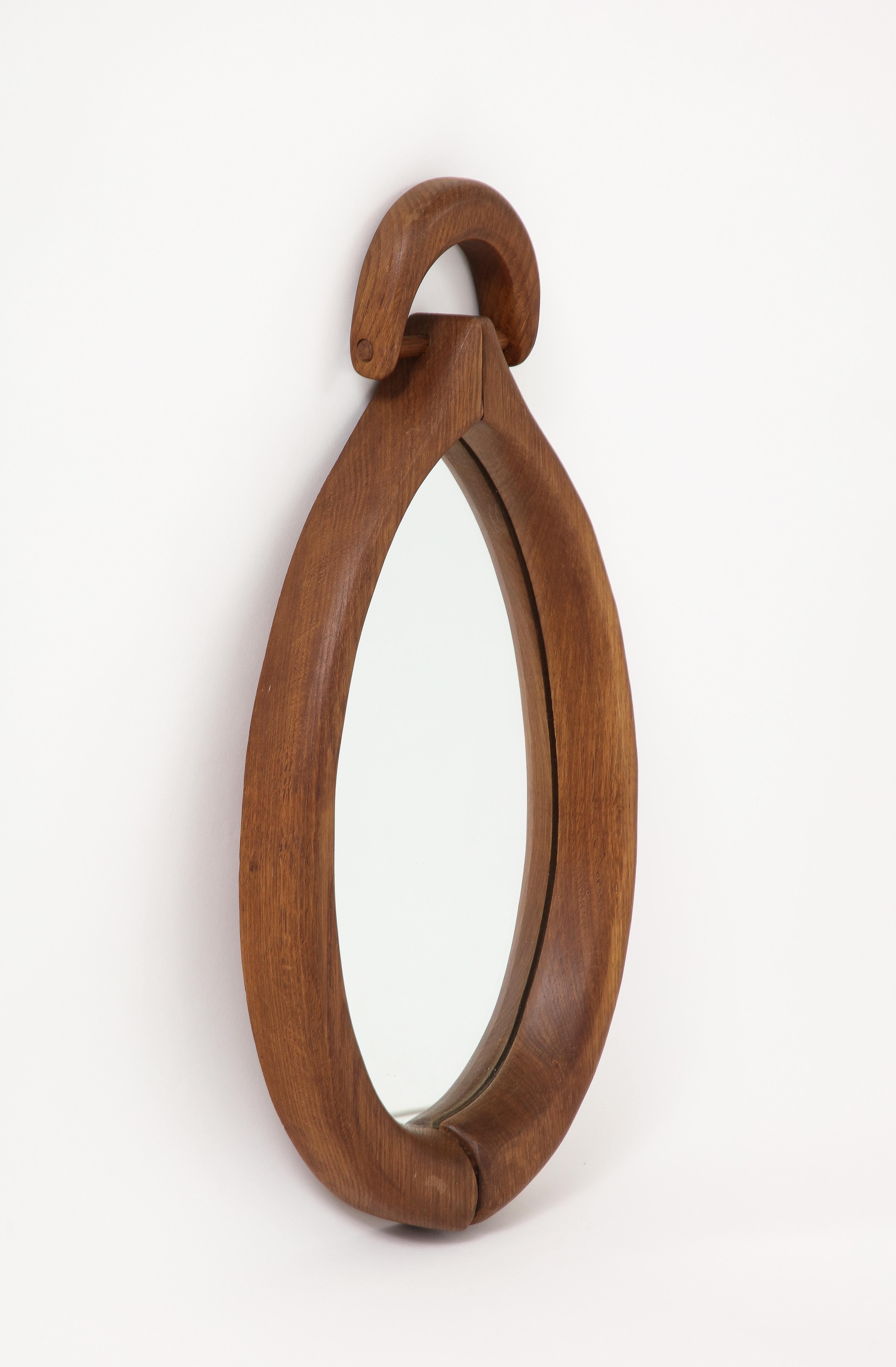 Minimalist drop-shaped wall mirror made of solid wood. In good vintage condition.
France 1960's.