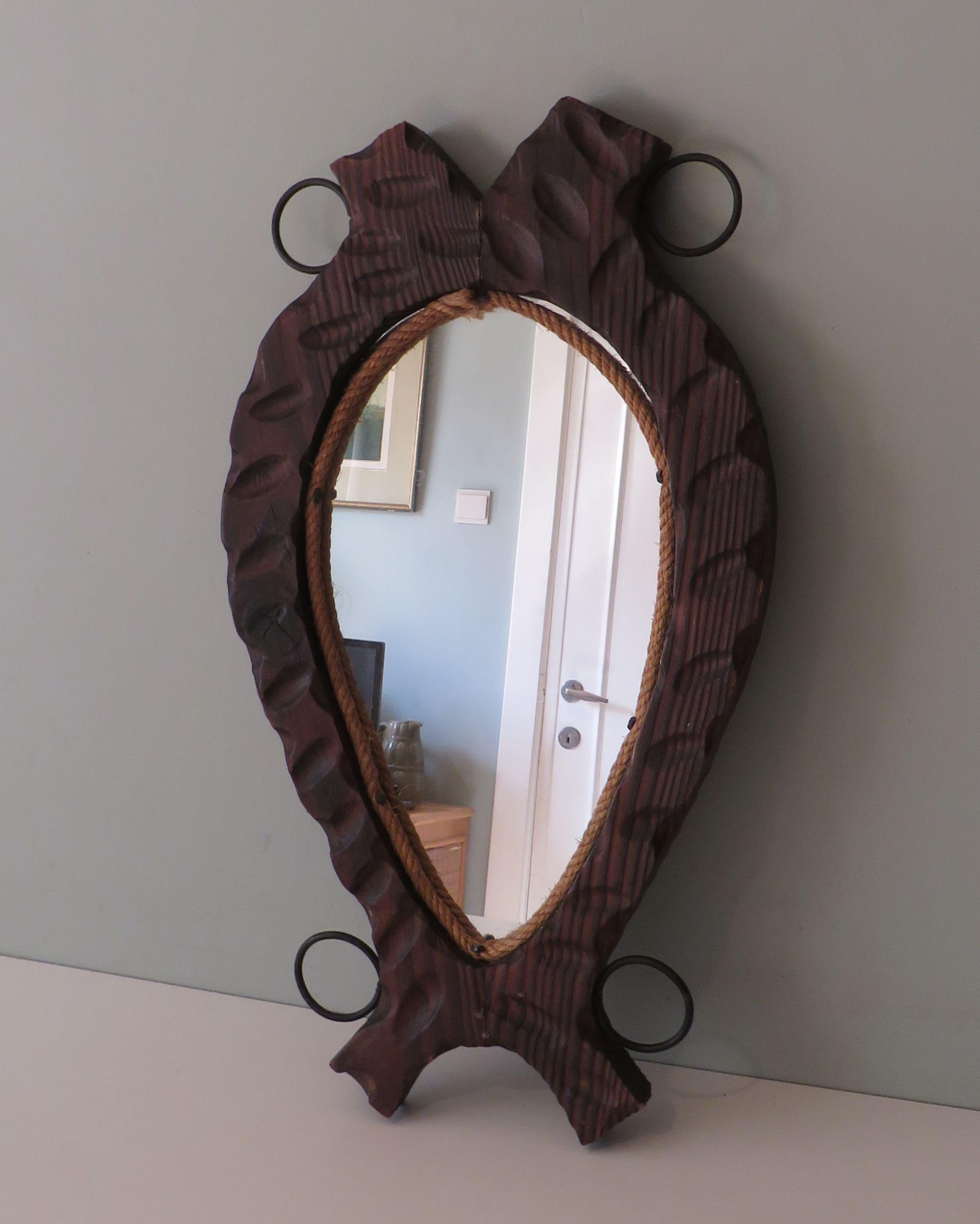The mirror has a harness-shaped dark wooden hand-carved frame and
finished with natural cord that is attached with decorative black cast iron nails.
The mirror is also equipped with a hanging hook on the back.
The mirror is in good condition, the