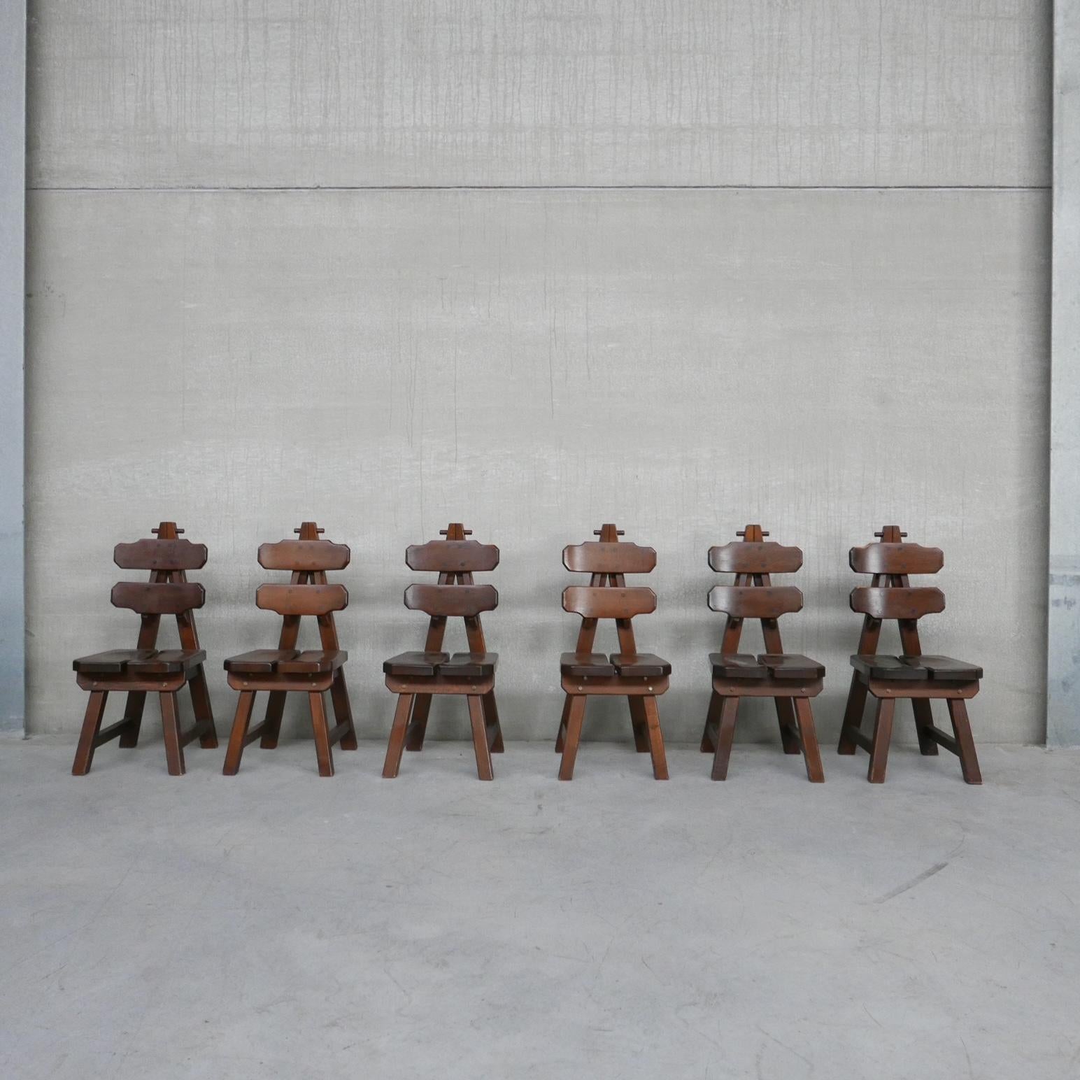 A set of solid oak dining chairs. 

Spain, c1970s. 

Thicky chunky wood with peg joints. Lots of character but also remaining comfy and stylish. 

Good condition, some wear commensurate with age. 

Can be refinished by our restorer to taste