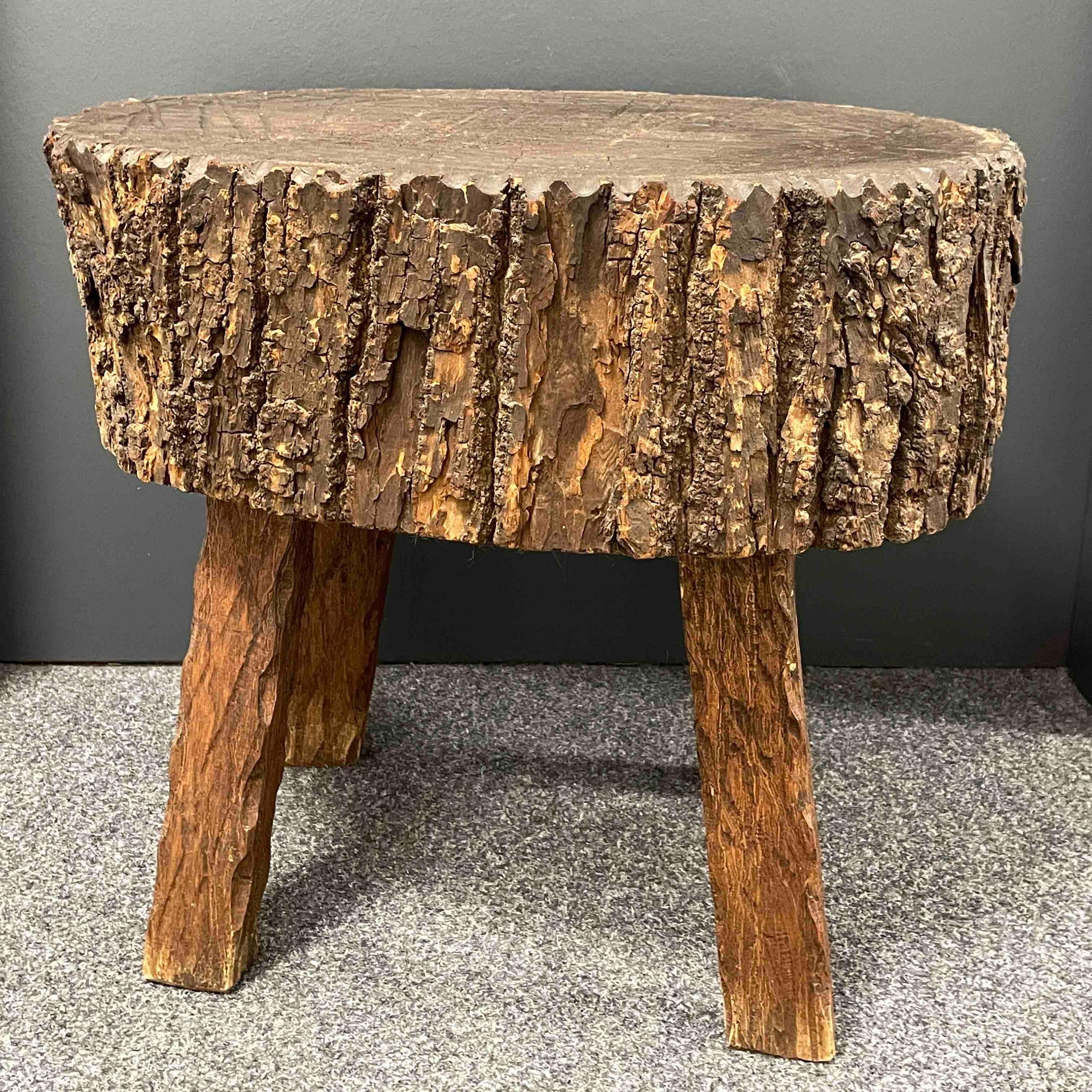 Offered is this Provincial antique rustic brutalist style chopping block table, circa 1960s or older. Nice primitive side or coffee table with lovely nice patina and stress cracks adding to its charm. Bold and strong this table is an early and solid