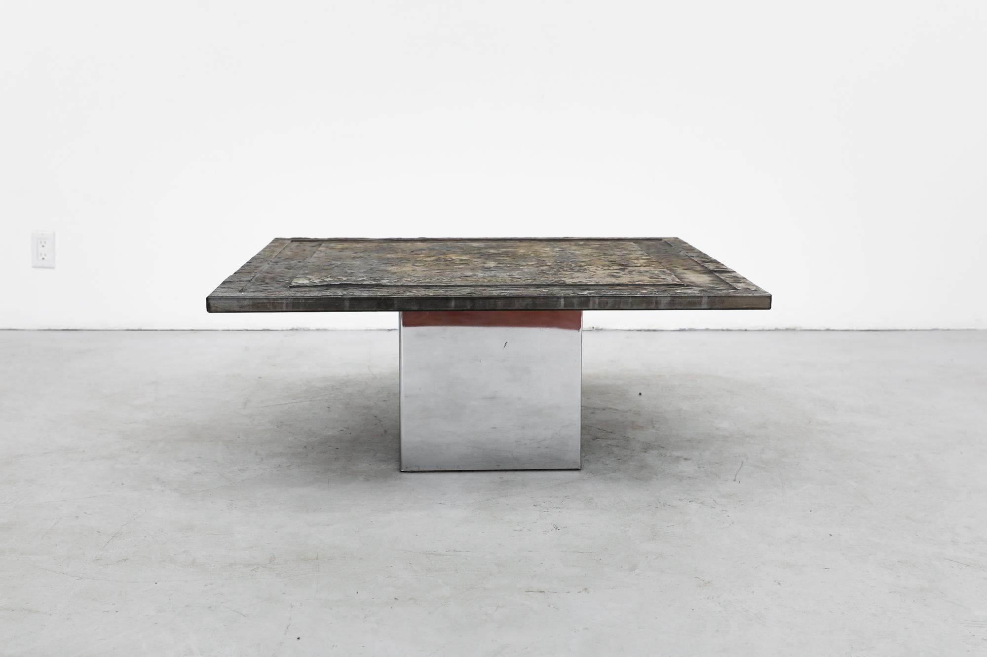 Brutalist coffee table with stone top and chrome pedestal base. The stone top has deeper carved inset border. In original condition with visible wear consistent with its age and use.
